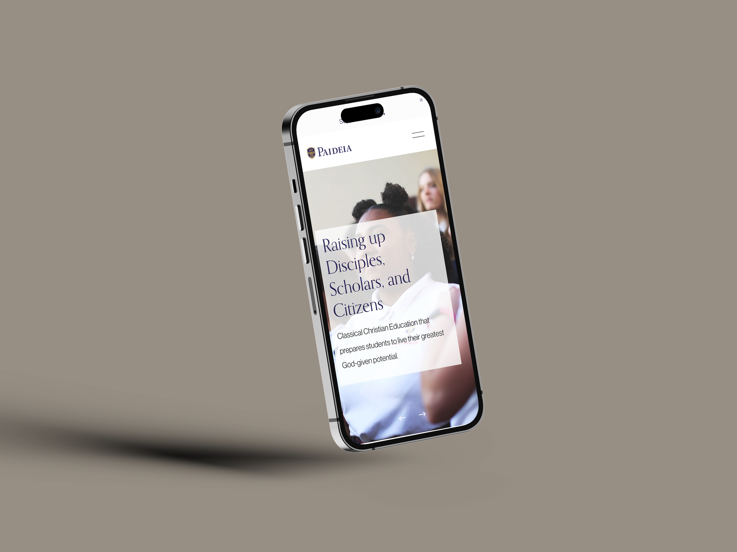 Smartphone displaying a website for Paideia with the headline "Raising up Disciples, Scholars, and Citizens" on a plain beige background.