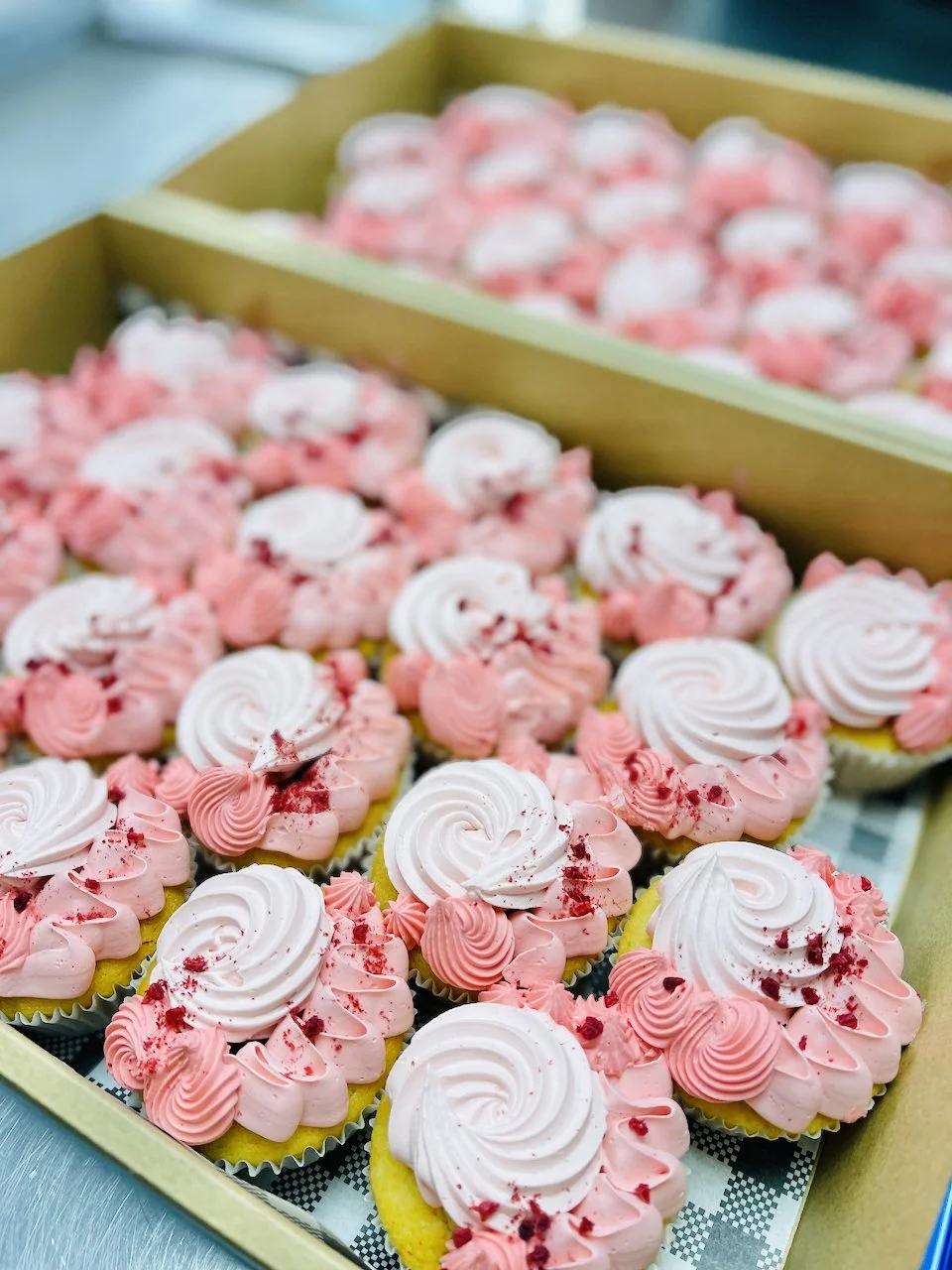 Boxes of pink cupcakes