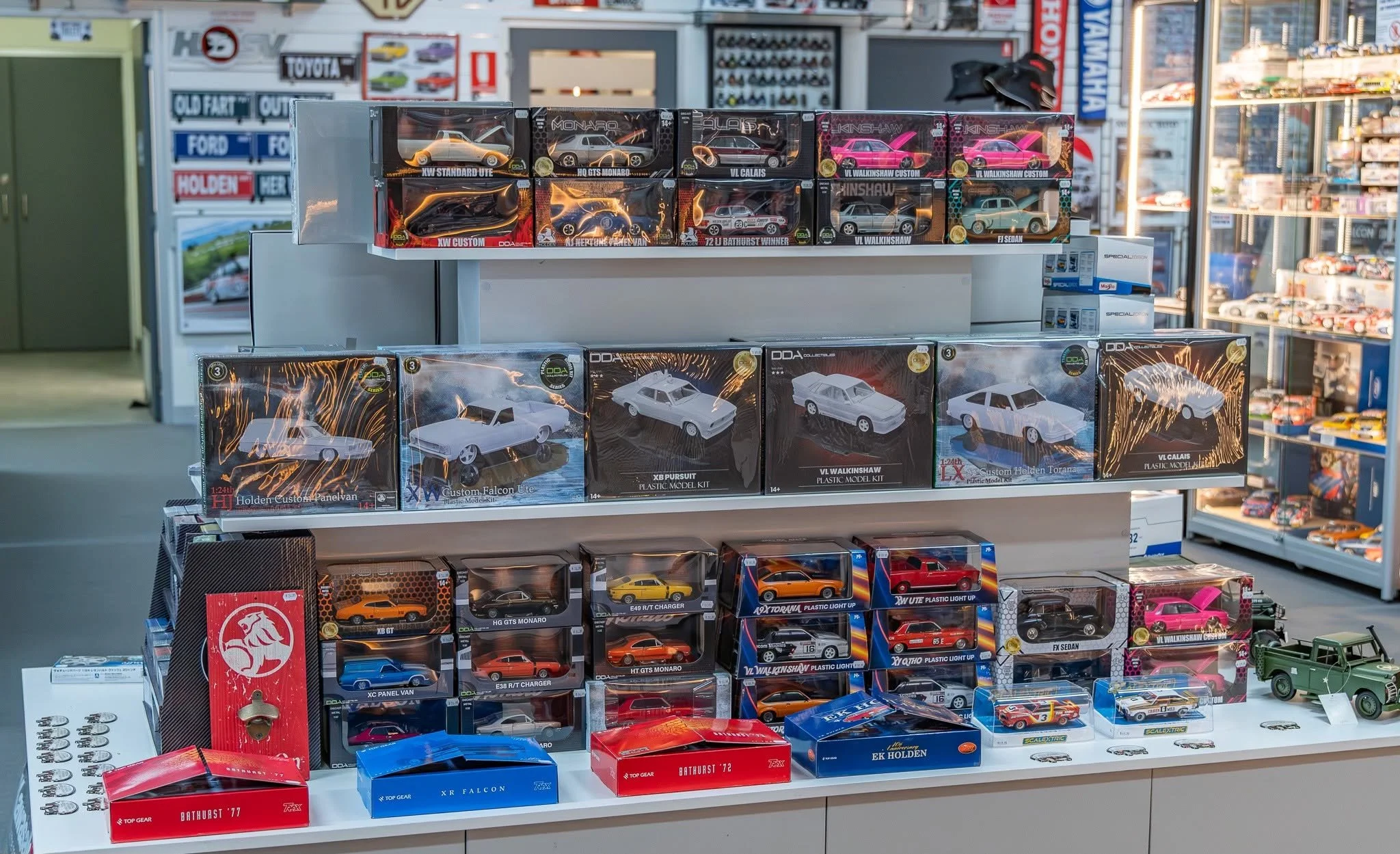 Display of miniature toy cars in boxes on store shelves, with various models and brands visible in the background.