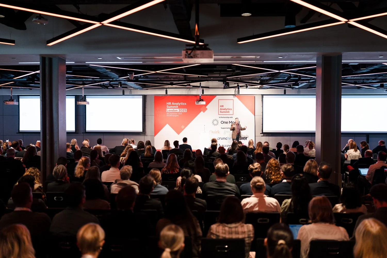 A full audience watching a speaker at a People Strategy Hub event