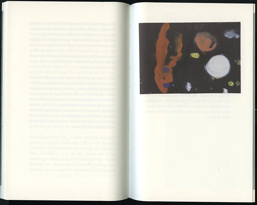 A book opened to reveal a blue and white image within its pages.