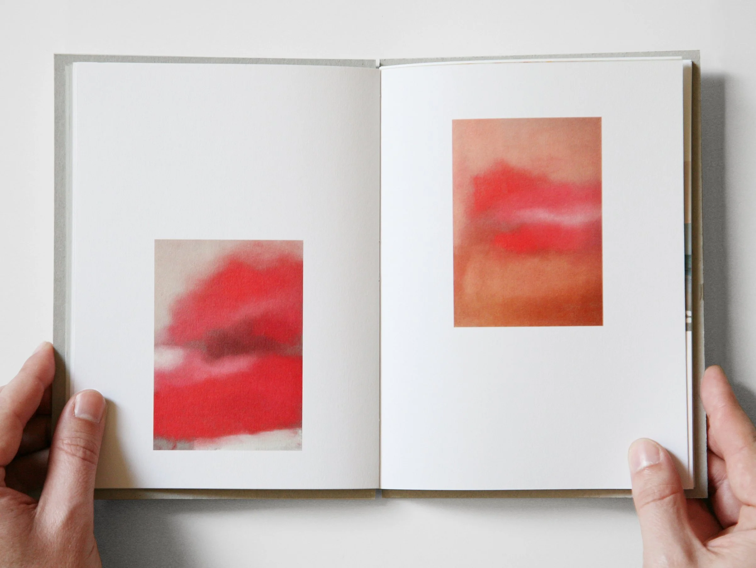 Two images of a book covered in red and pink paint, showcasing its artistic and colorful design.