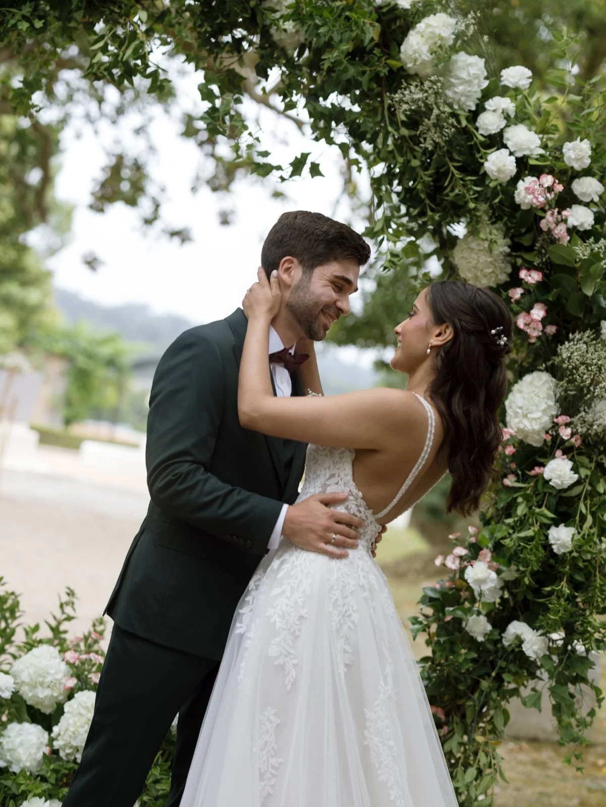 Daniel Vina wears a three piece bespoke wedding suit by London Tailor Roberto Revilla, Priya wears a white Rosa Clara wedding dress