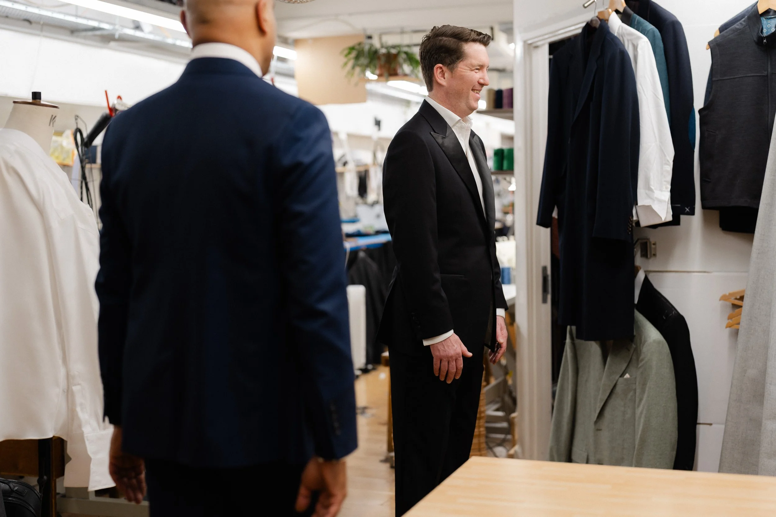 London Bespoke Tailor Roberto Revilla in his workroom fitting a new client for a new bespoke dinner jacket.
