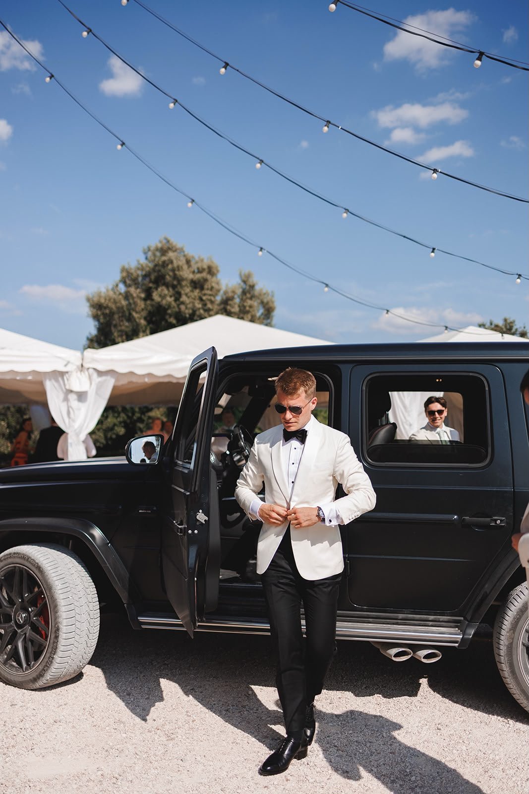 Oliver & Nikkita Vass - Oliver wears white tuxedo jacket and black dinner trousers, with dress shirt also made by Roberto Revilla London