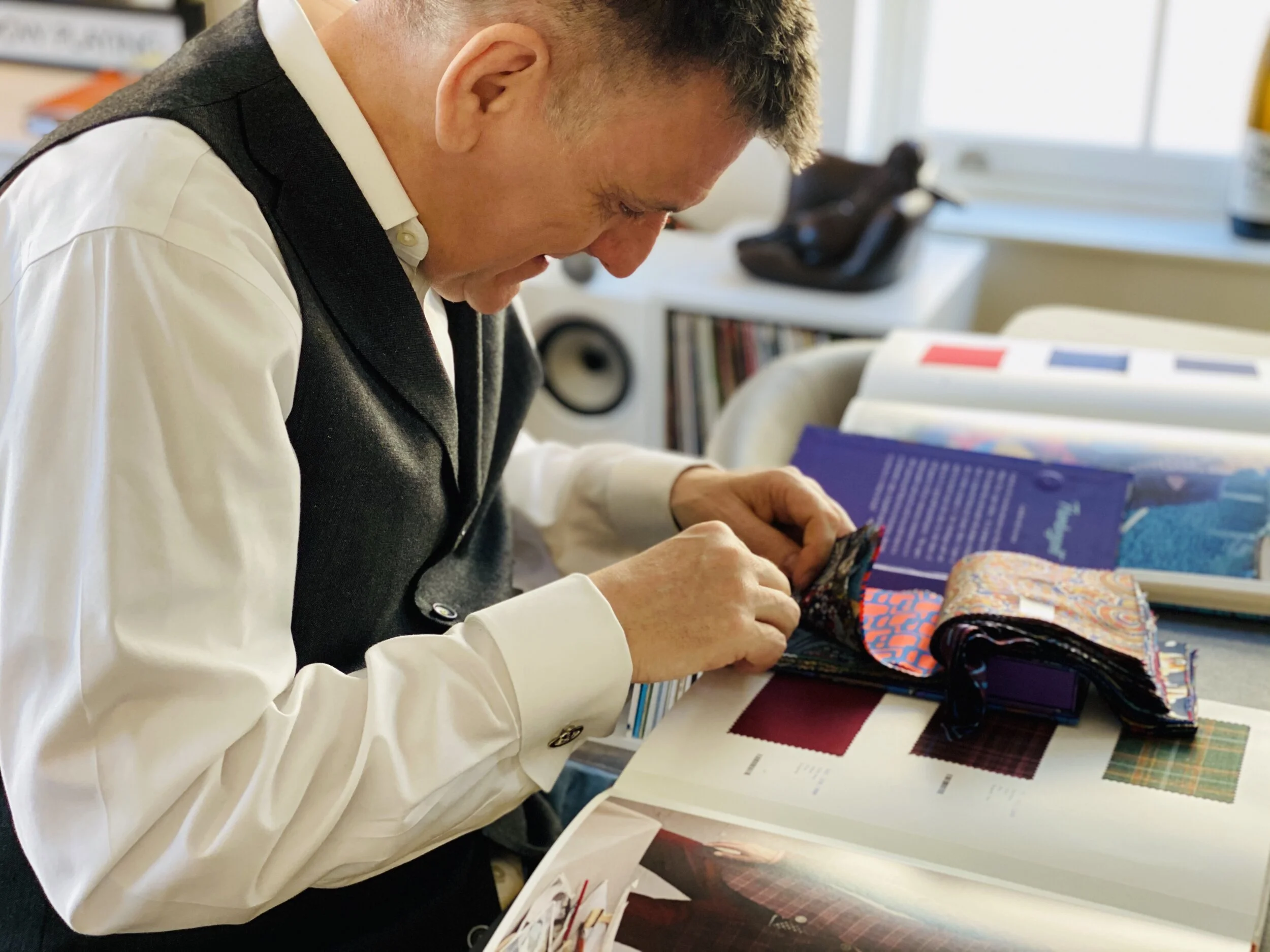 Mike Hobday of AntWorks choosing fabrics and linings for a new bespoke suit by Roberto Revilla London