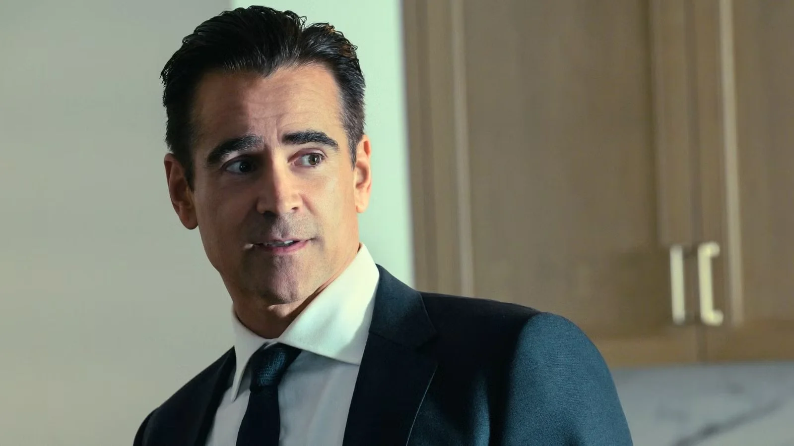 Colin Farrell as John Sugar in a dark tailored suit and tie in Apple TV’s Sugar