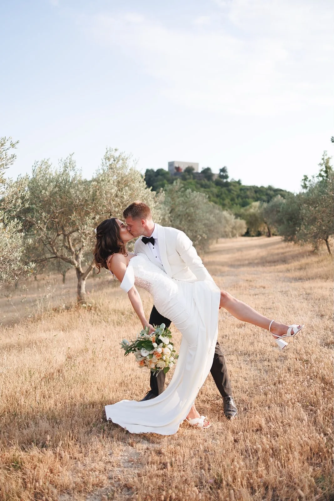 Oliver & Nikkita Vass - Oliver wears white tuxedo jacket and black dinner trousers, with dress shirt also made by Roberto Revilla London