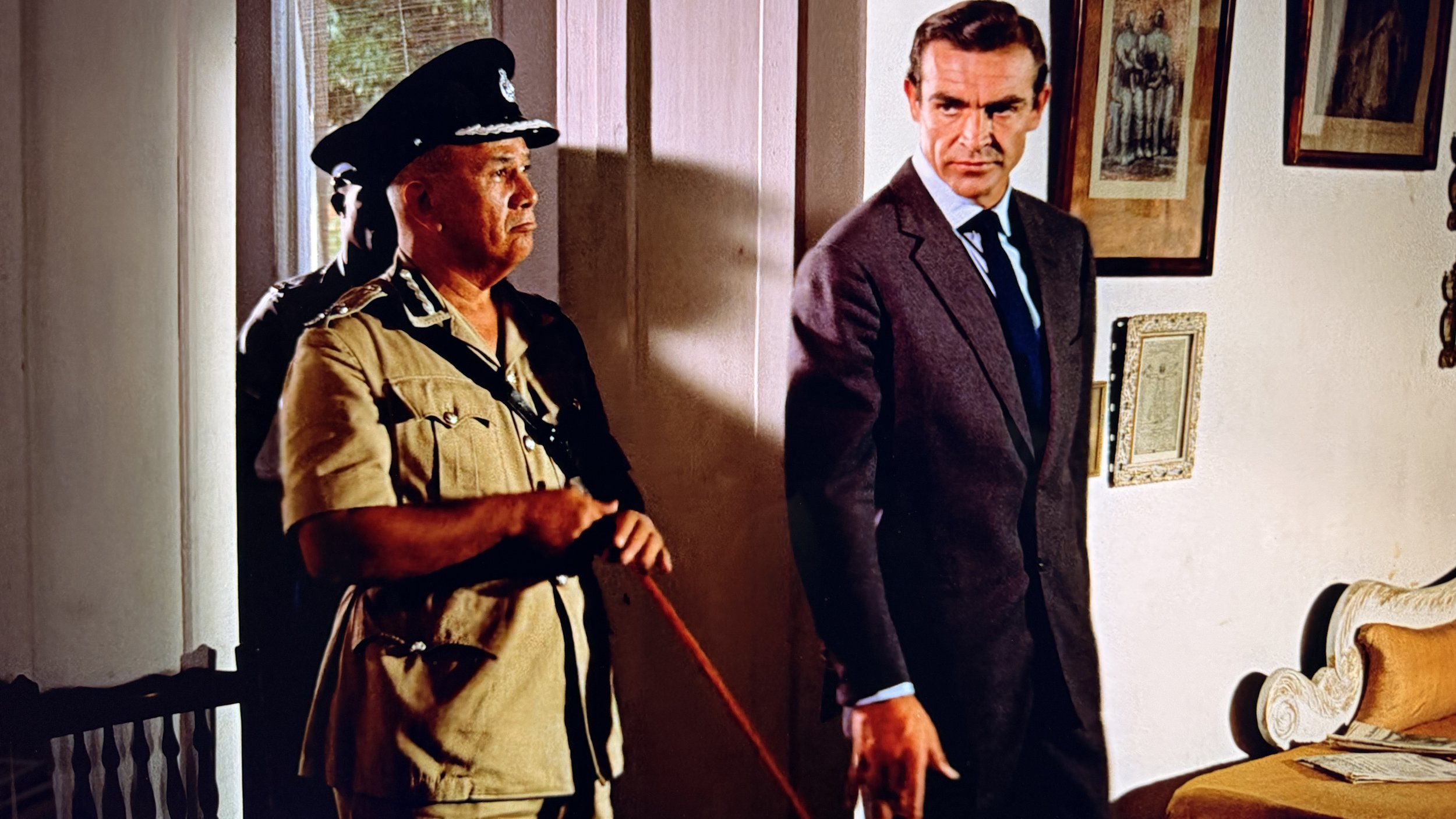Sean Connery as Ian Fleming's James Bond in Dr. No wearing a two piece, two button single breasted grey suit