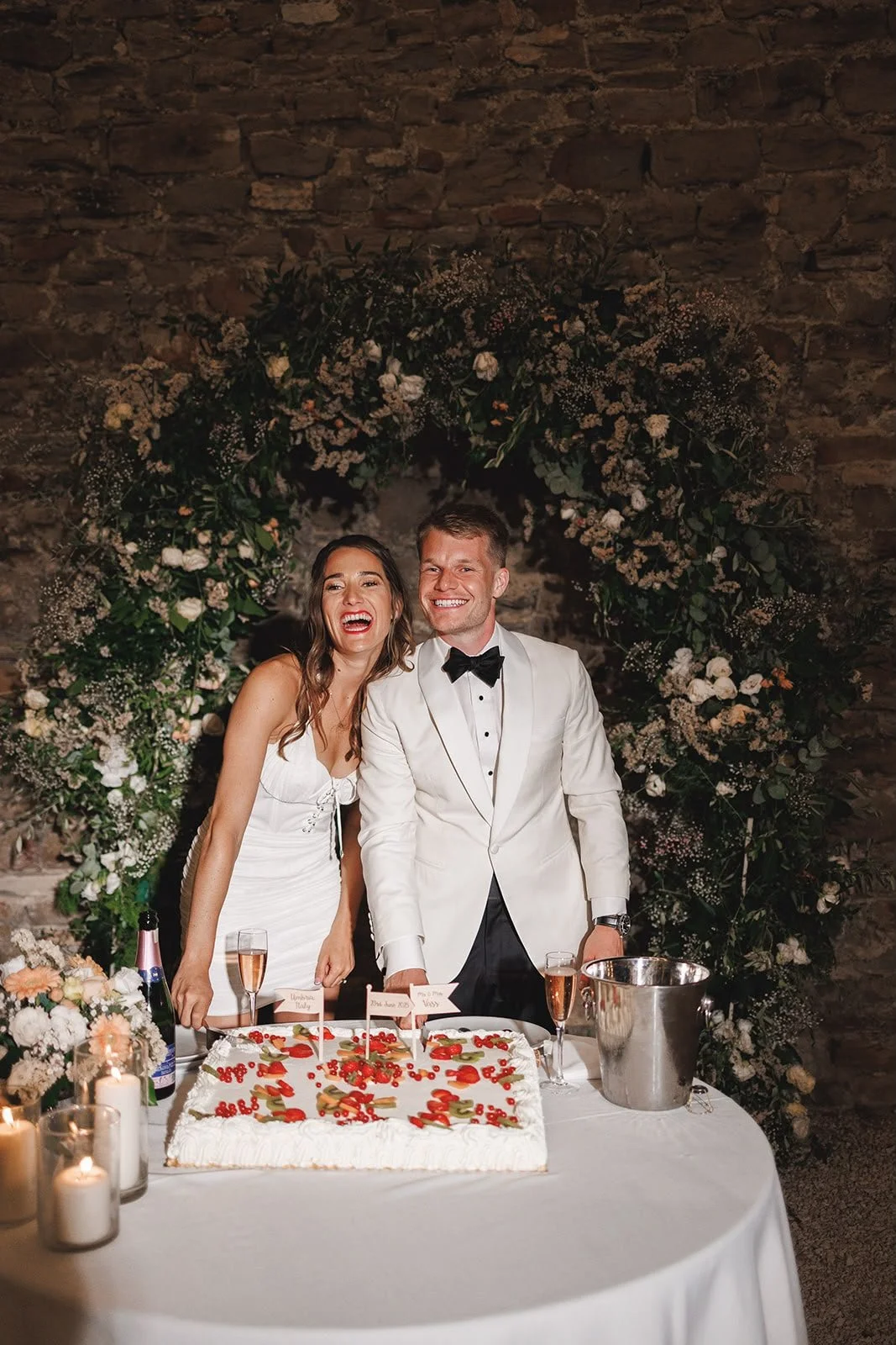 Oliver & Nikkita Vass - Oliver wears white tuxedo jacket and black dinner trousers, with dress shirt also made by Roberto Revilla London