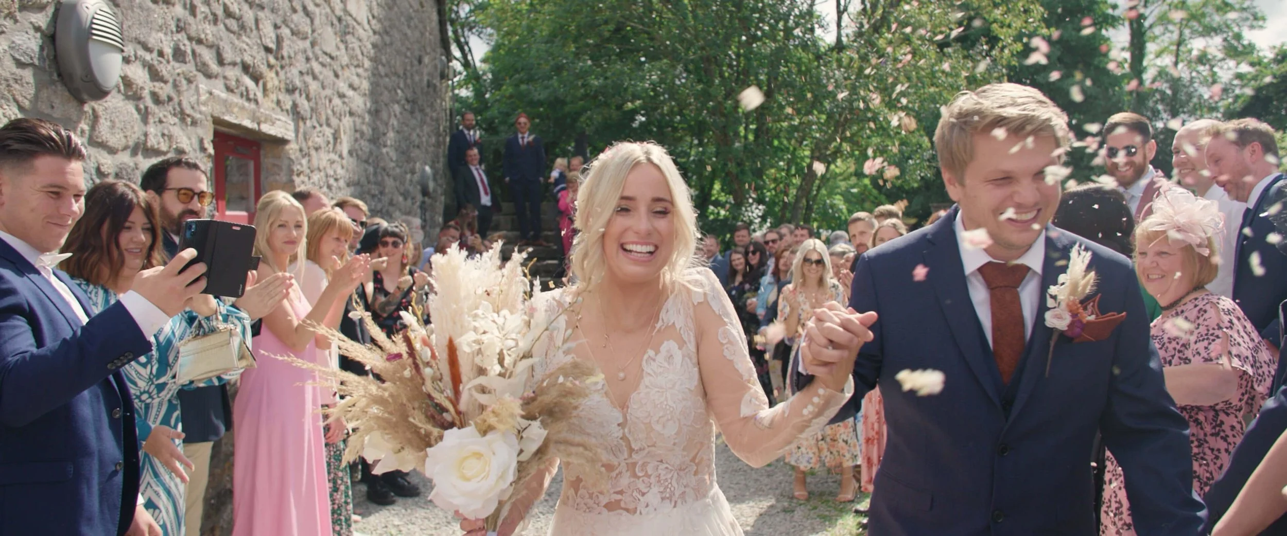 Dani & Darren at the end of confetti line excitedly
