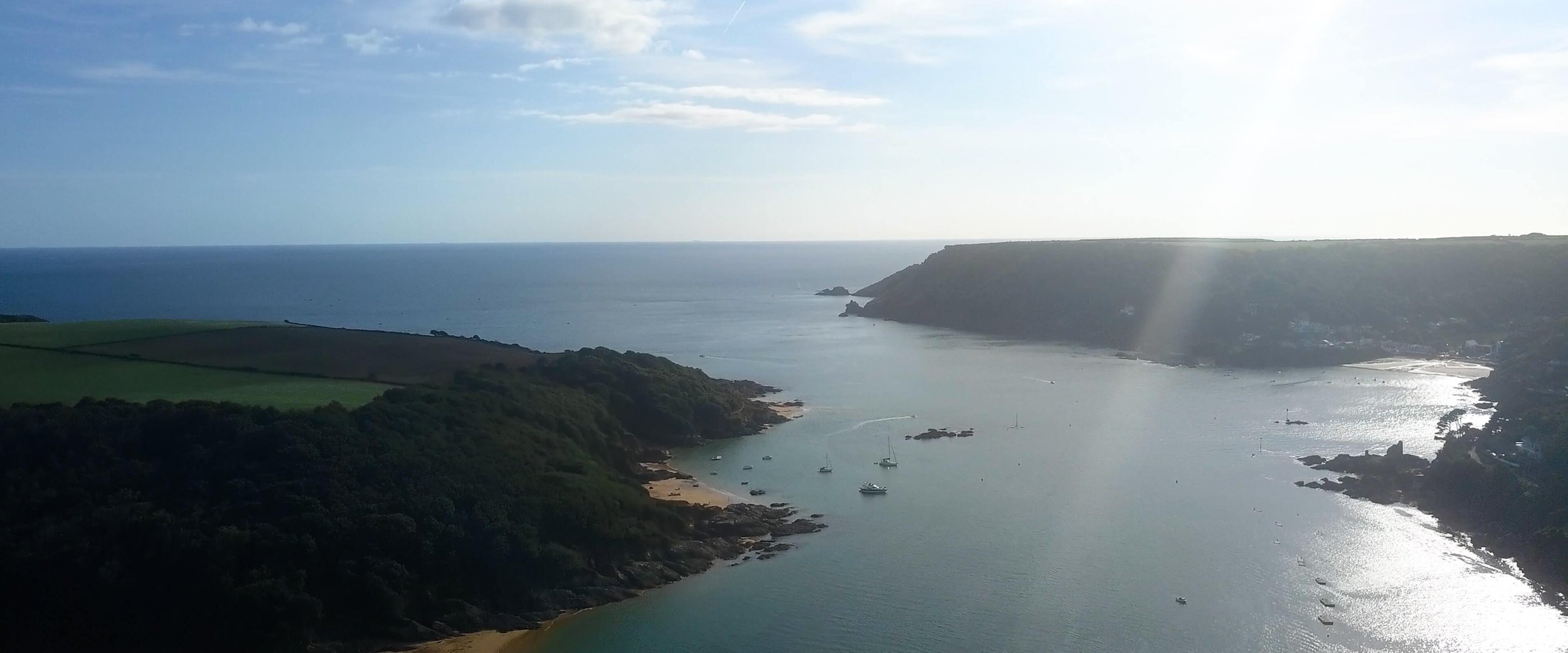 Aerial drone shot over Salcombe Estuary showing the mouth to the sea