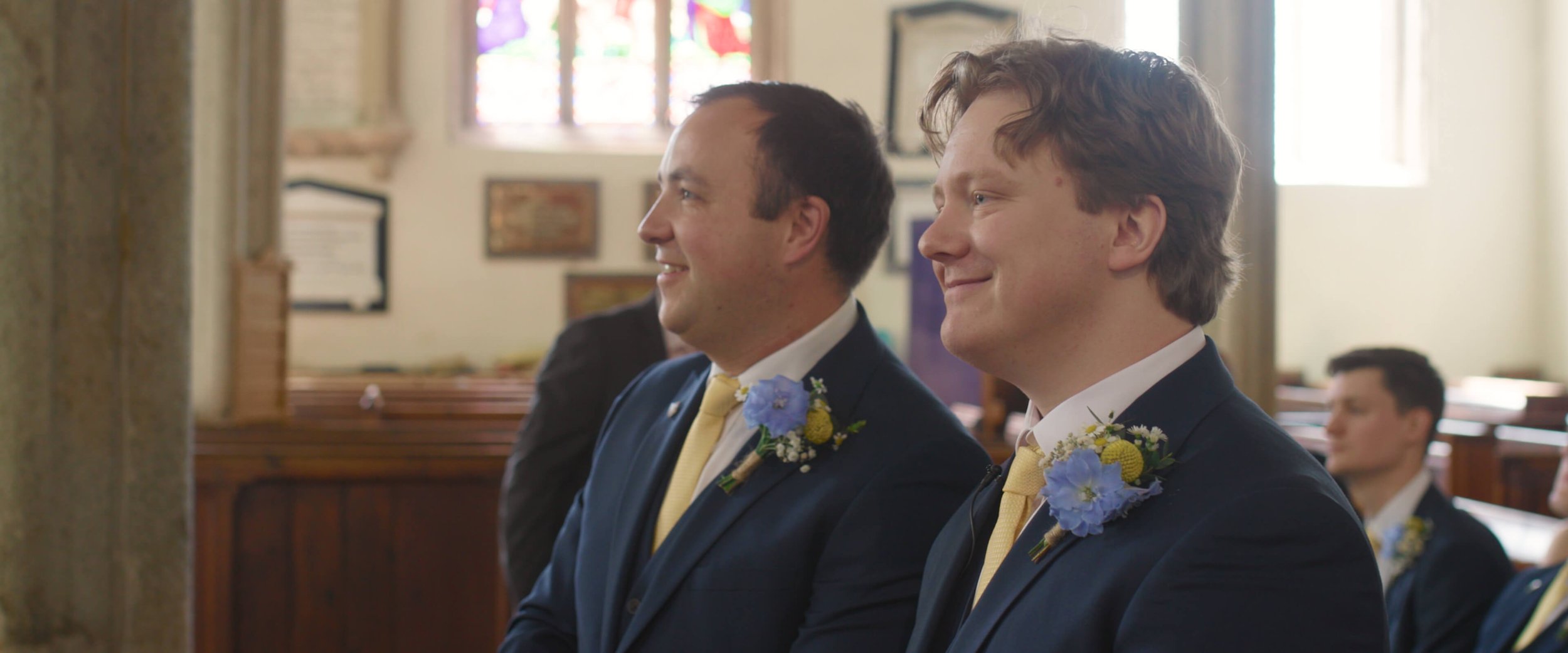 Dael smiles nervously next to best man whilst waiting for the bride to arrive at church