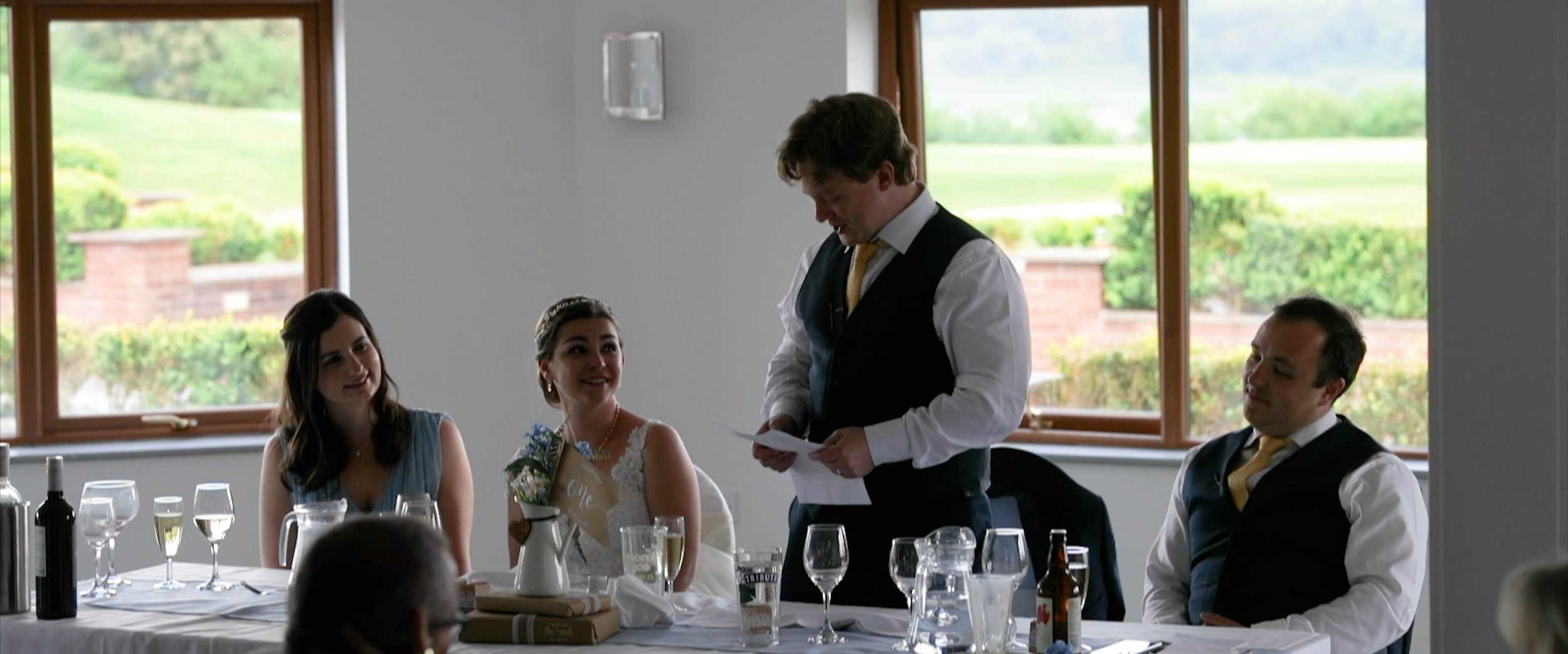 Dael delivering touching speech whilst Emma and the head table look to him with adoration