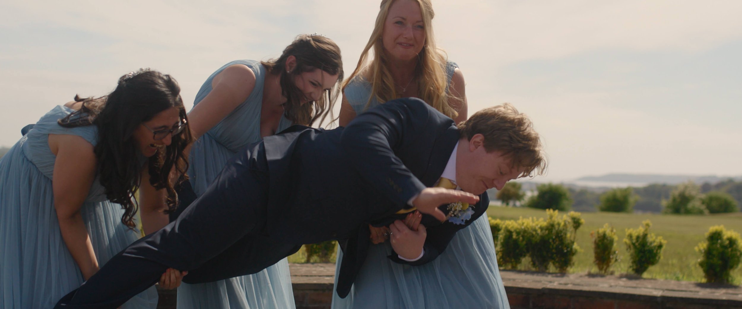 Dael captured mid-fall as the bridesmaids try to pick up him and fail