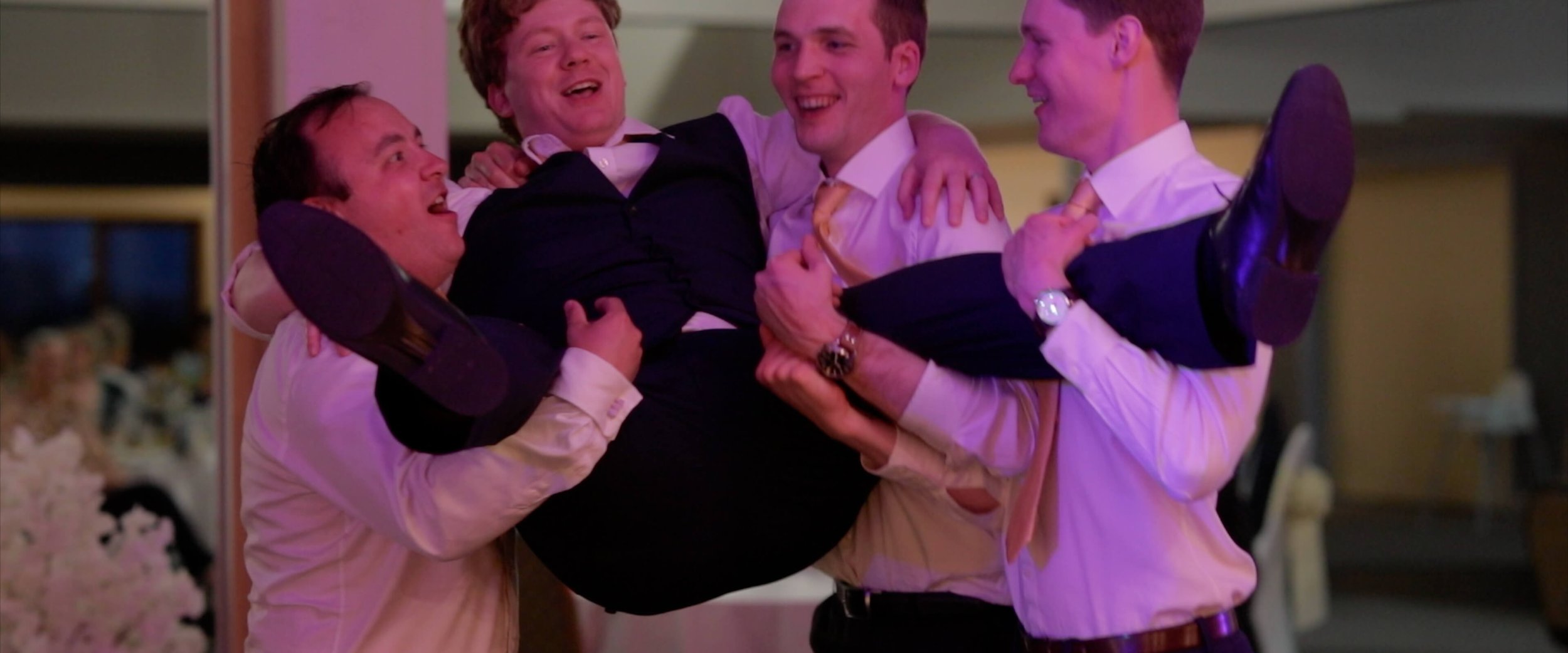 The drunk groomsmen carrying Dael around the dance floor