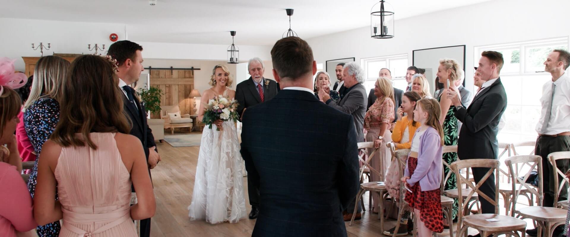 Chris sees Michelle walking down the aisle with her father for the first time
