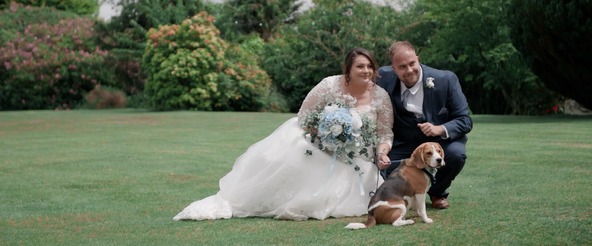 Jade, Jordan and Hugo the Beagle sit on the Moorland Hotel football field for a wedding photo