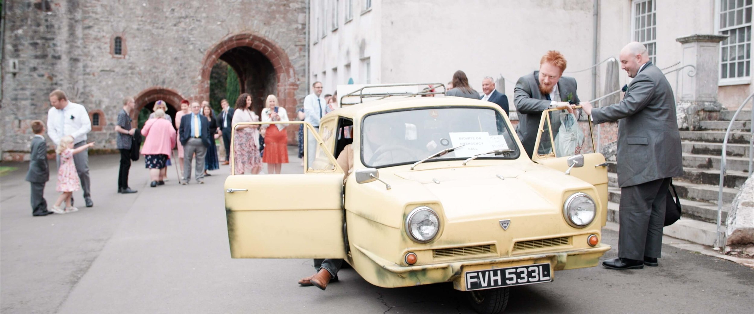 Best man exits the Only Fools and Horses themed 3-Wheeler car with a Del Boy impersonator and enters wedding ceremony