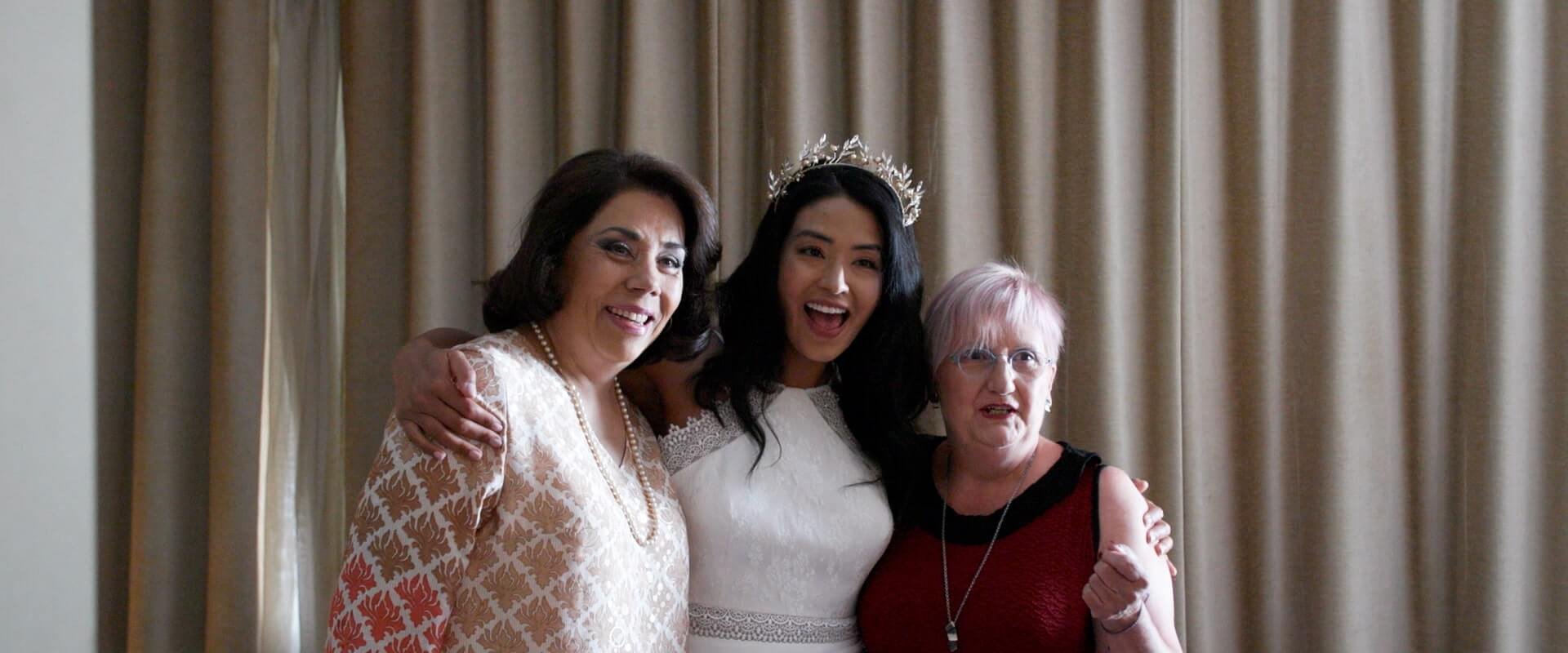 Rita and her closest family smile &amp; laugh for a photo before they leave for the wedding ceremony