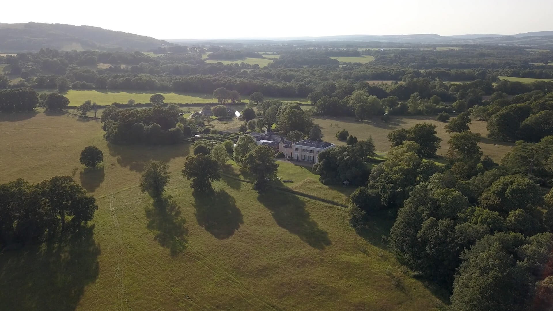 Aerial drone shot of Bignor Park Estate House from a distance
