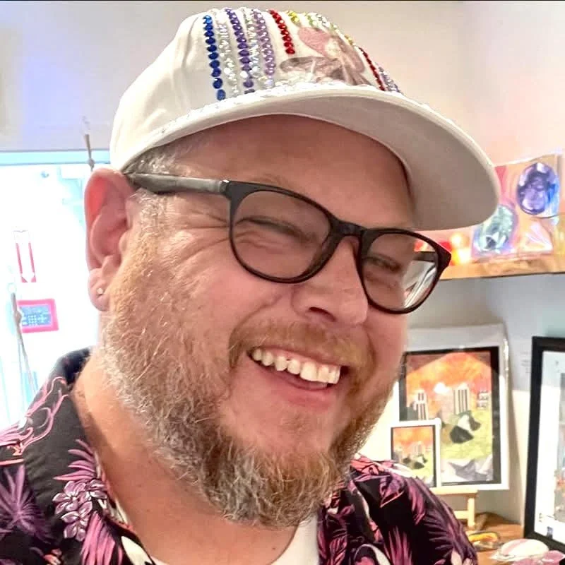 A nice gentleman smiling with glasses