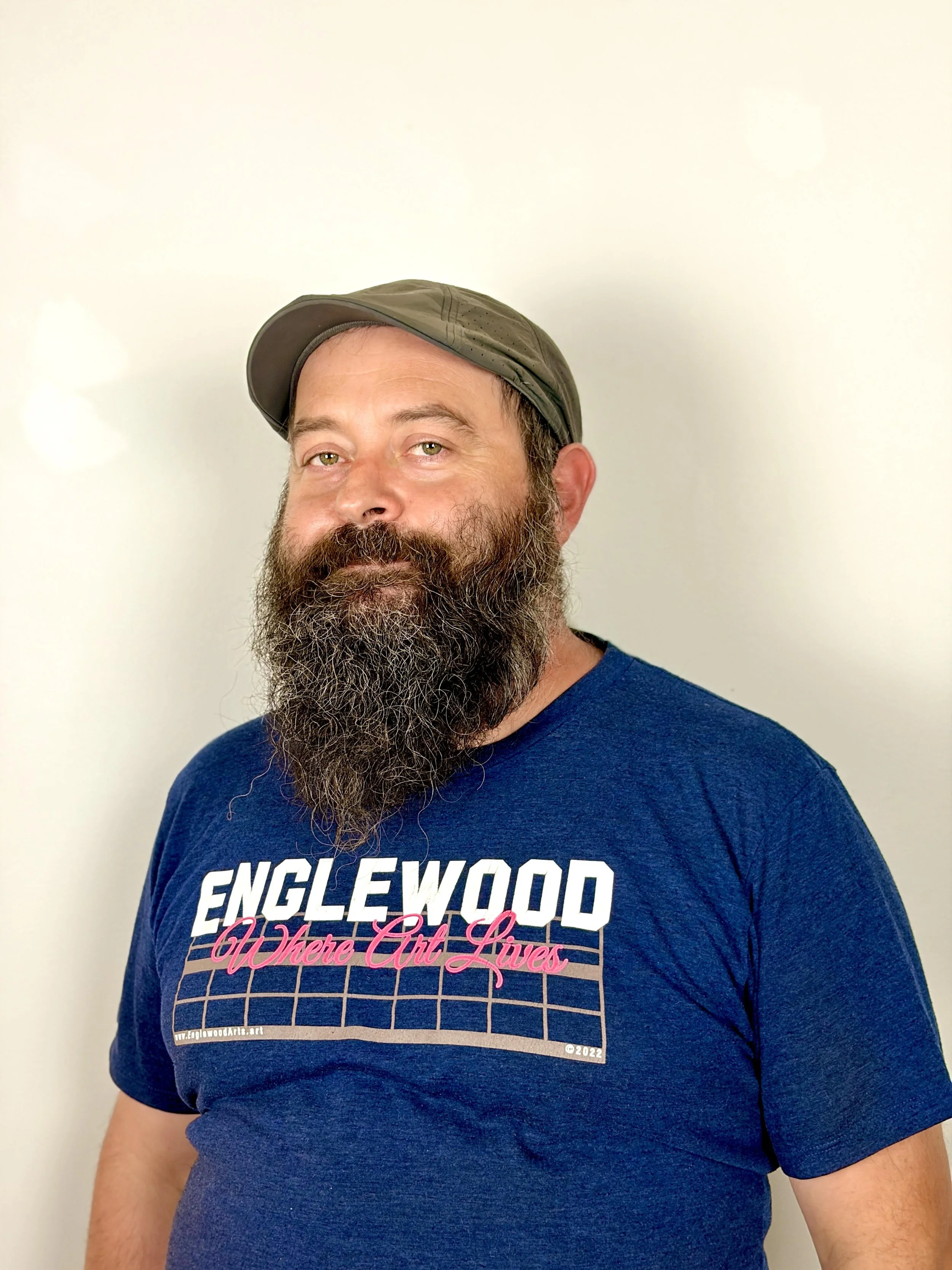 rugged man with beard and a cap