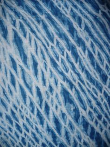 Fabric died blue in an intricate pattern using arishi shabori method