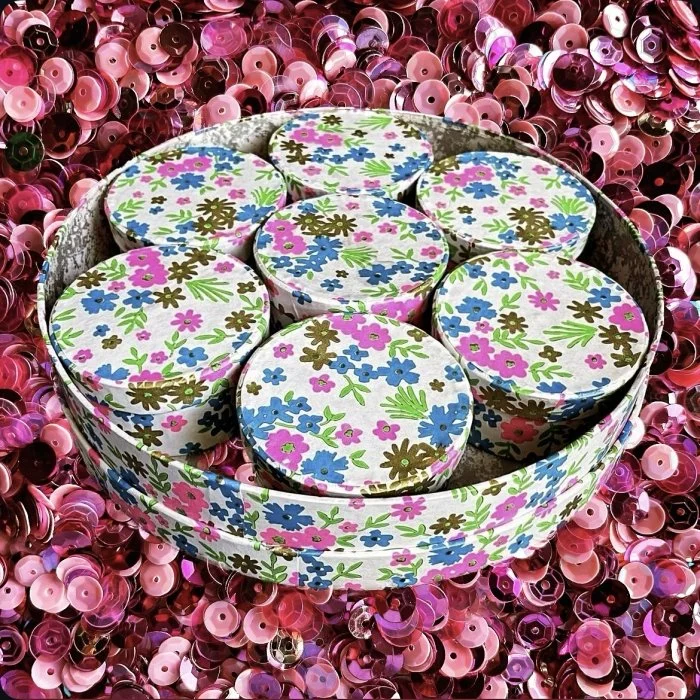 Colorful floral print boxes nestles in sequins