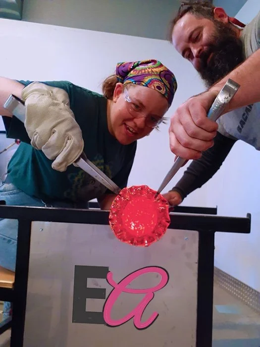 two glassblowers creating glass art