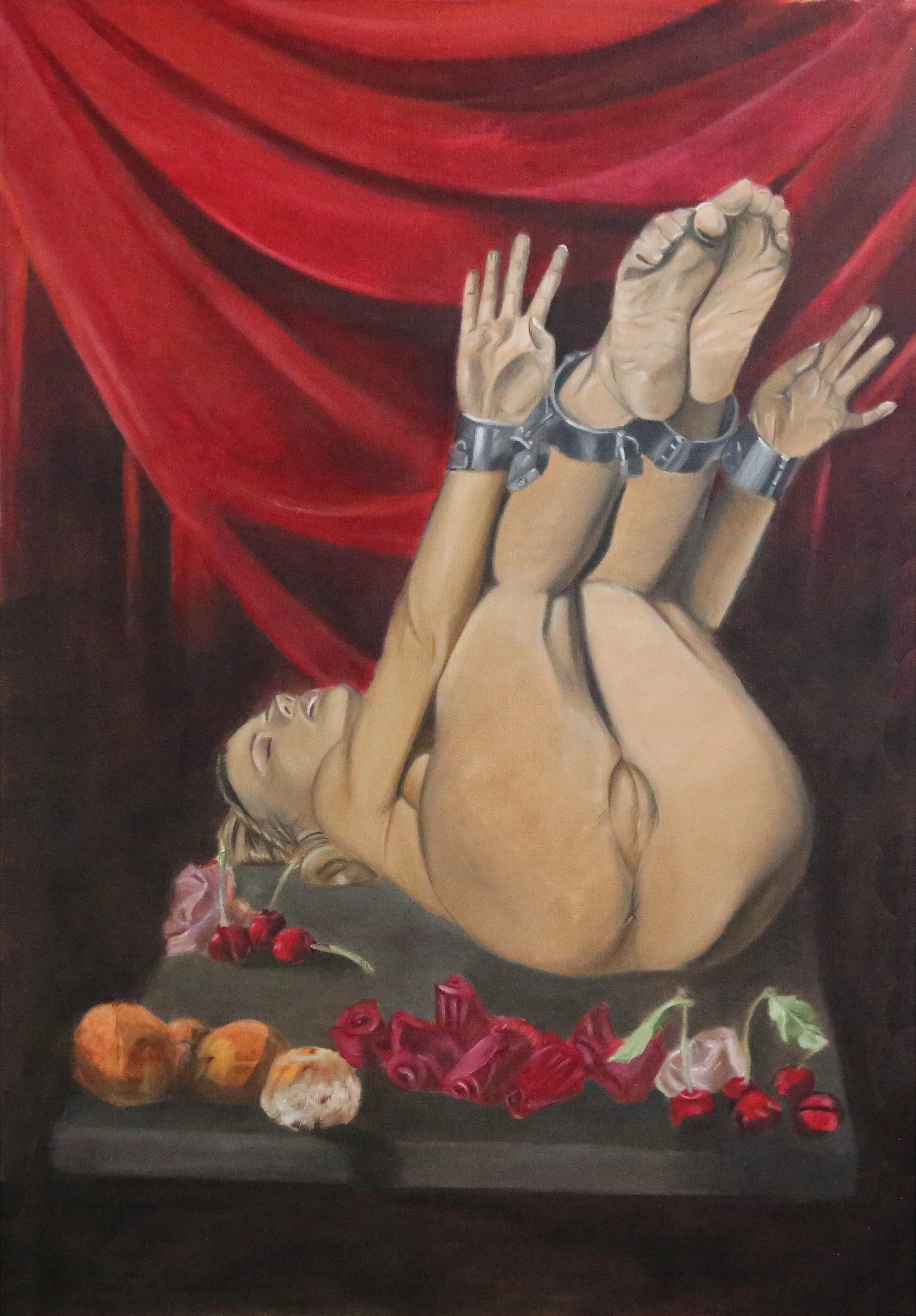 A painting depicts a nude woman lying on her back, hands bound with metal cuffs, raising her legs in the air with feet against a red curtain backdrop. There are flowers and fruit on a surface below her.