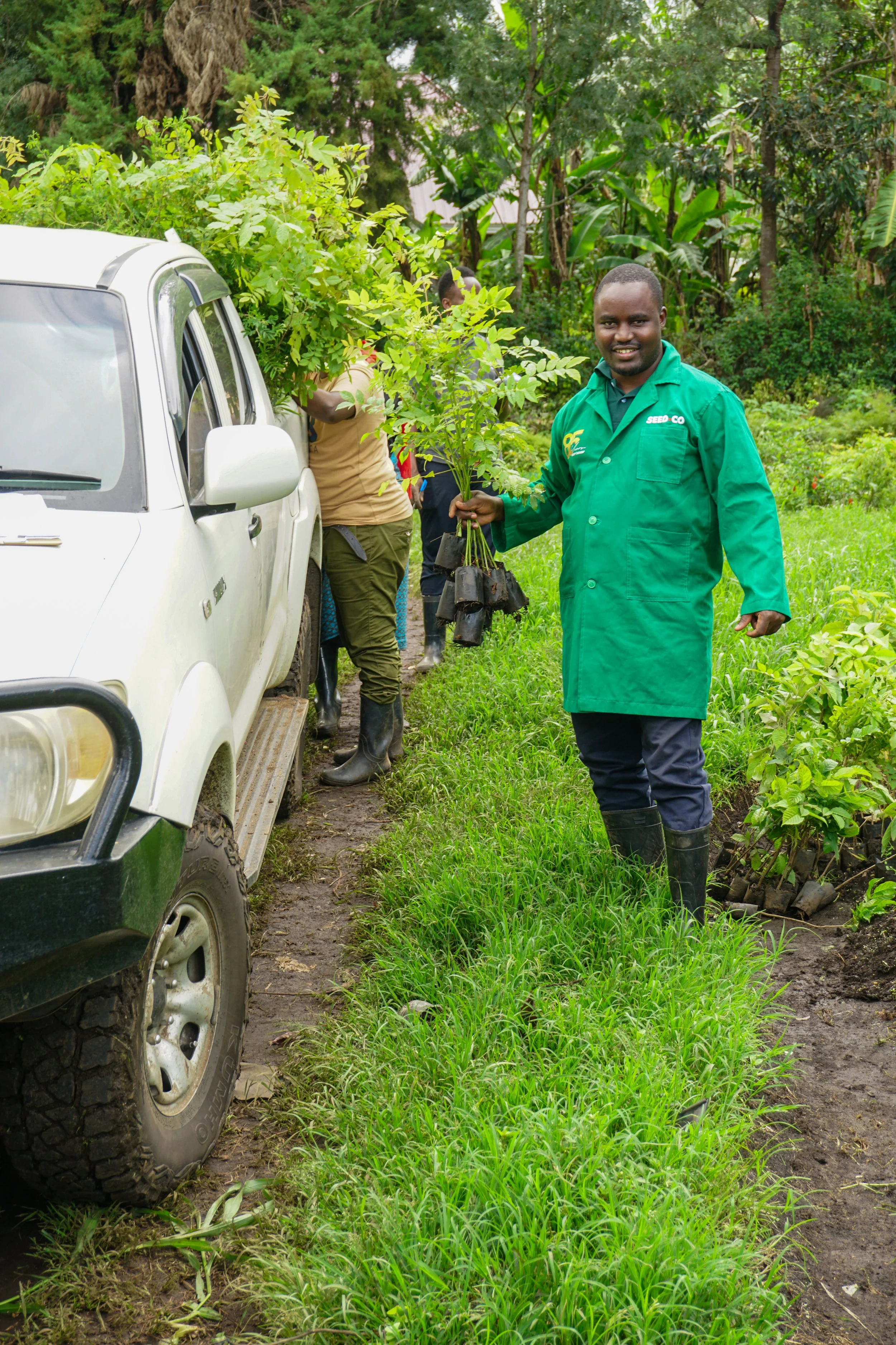 Saing'orie helping deliver trees to our women's groups.