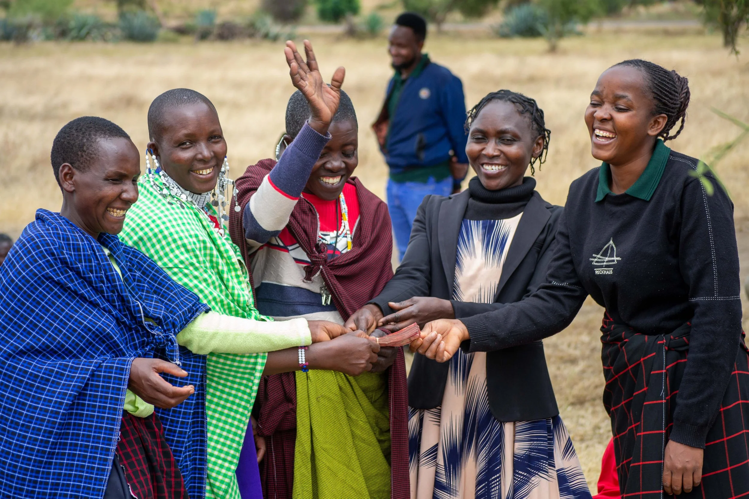 Women splitting profits from their women's group's successes at the end of the year.
