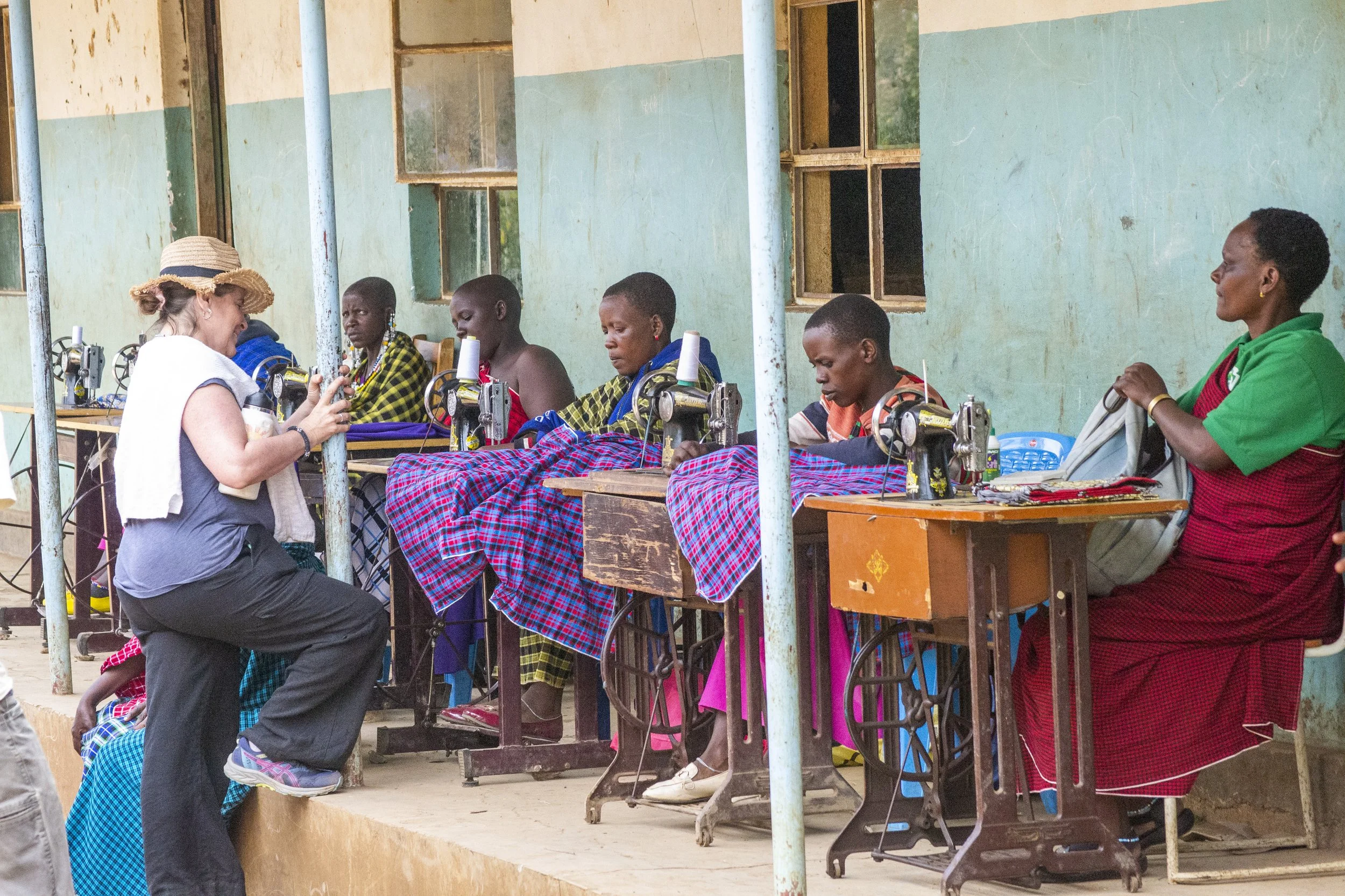 Women showing off the sewing skills they learned from training sessions.