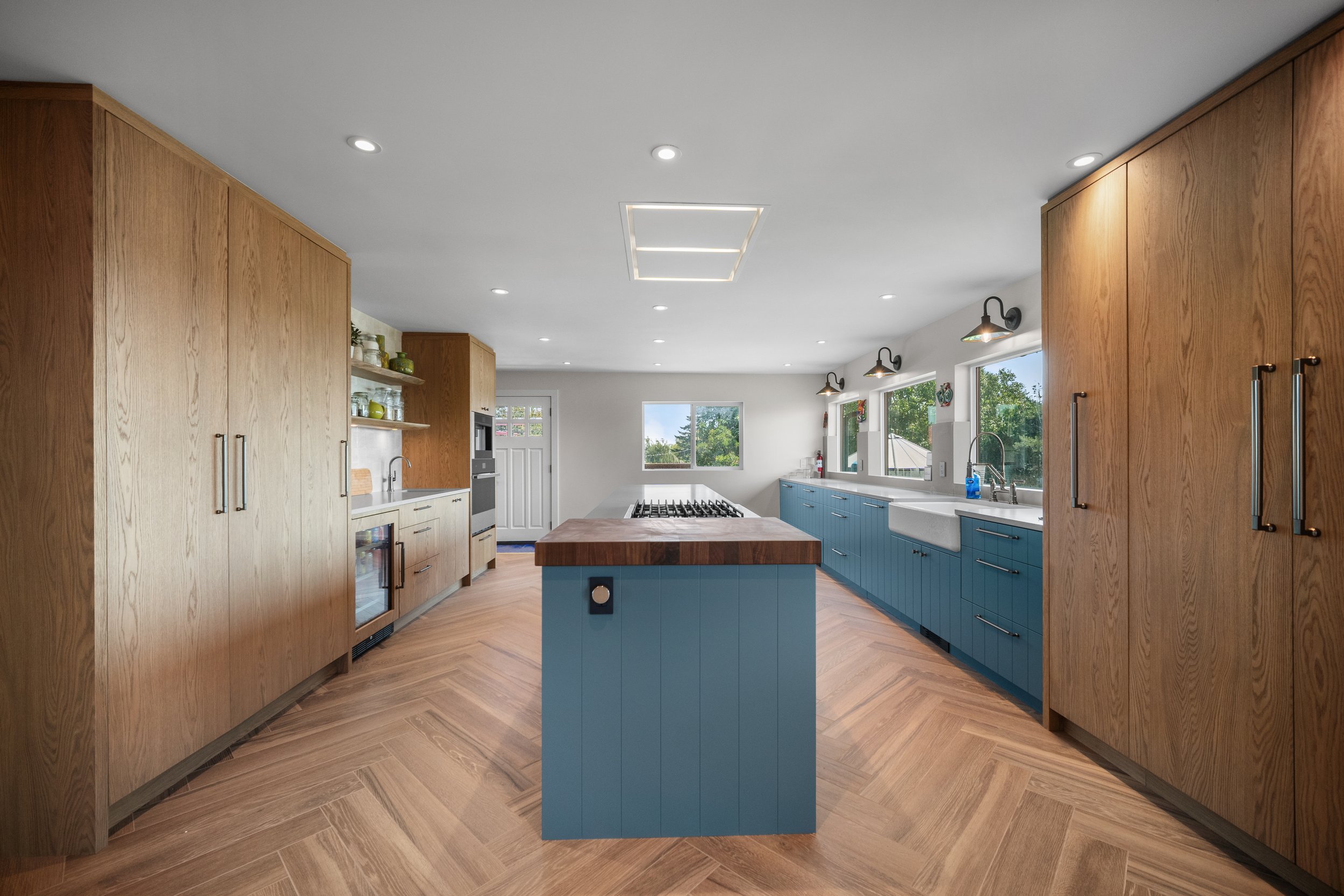 Delta industrial farmhouse kitchen with BC coastal blue island