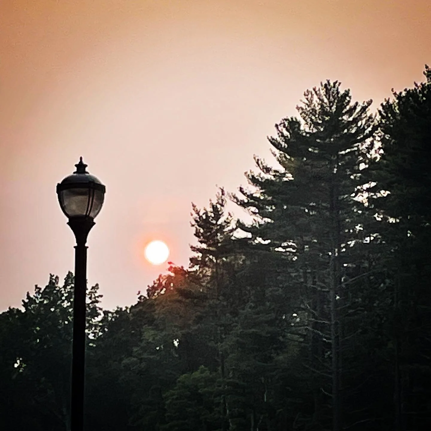 The sun burns brightly tonight.
She gives off a crimson color like that deep intense passion.
Her light reflecting and bouncing off that which she touches&hellip;
The haze softens the intensity as if to squash her power.
I look to the sun and recogni