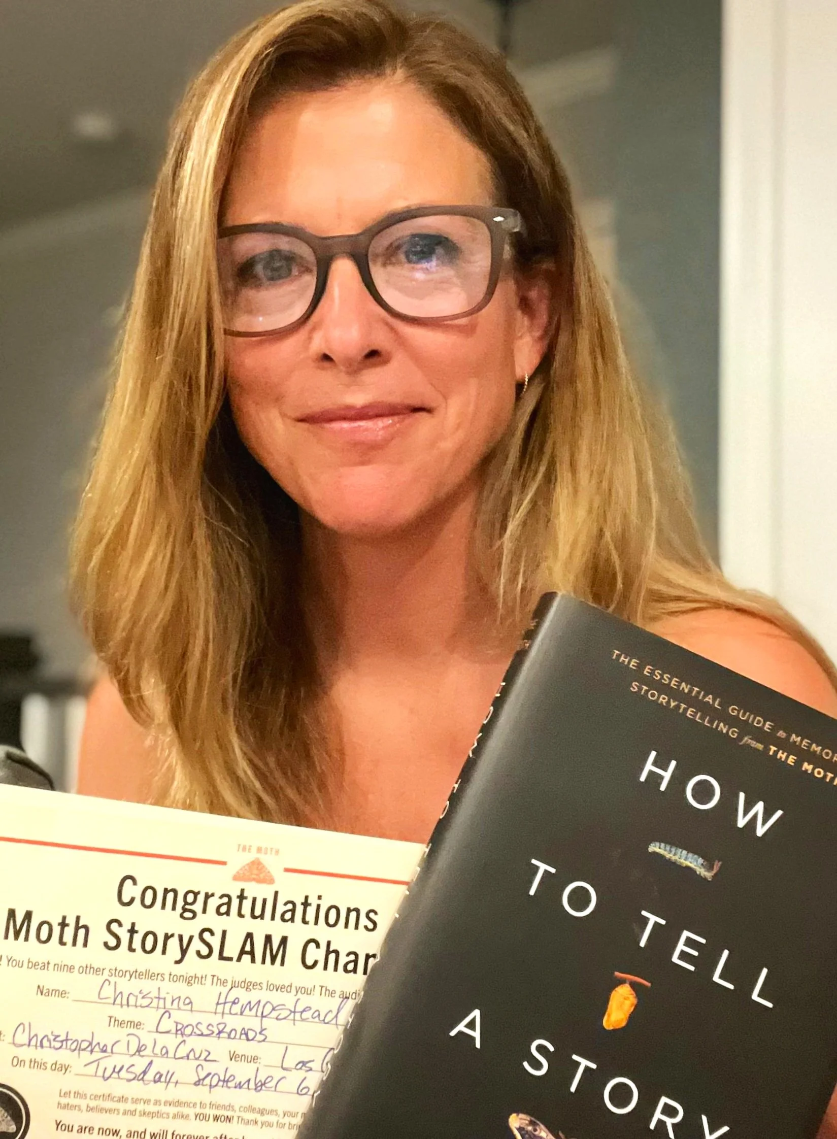 Christina is pictured here after winning THE MOTH Story Slam in September 2022