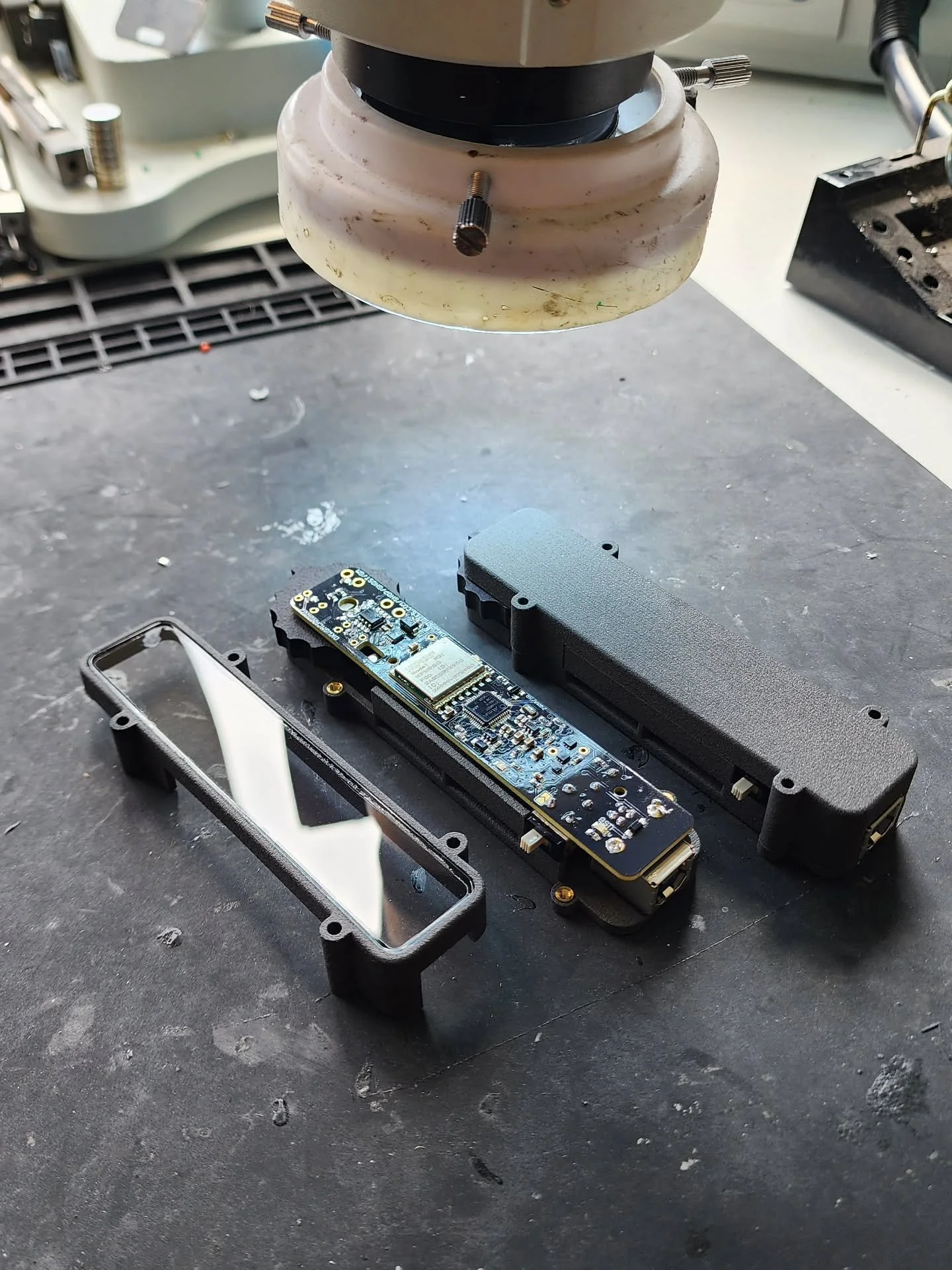 Gamechanger Module comes with two top pieces. The see thru one. And, the solid one. The board, DKWGMCHNGRV2, is silicone conformal coated. Same charging cord stule as the hand remote. Same method of updating the code, UF2, as the other ghost series p