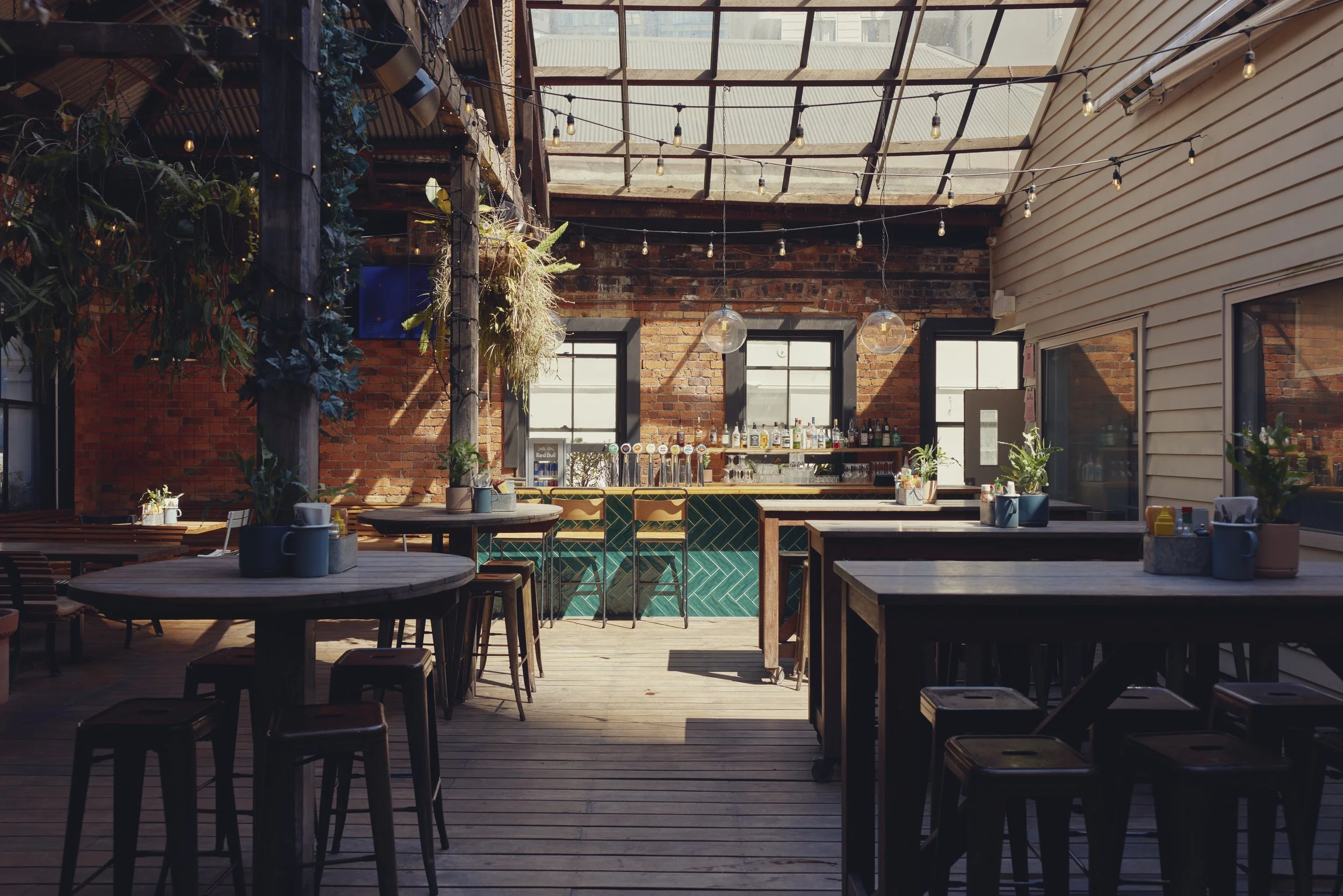 Outdoor leaner tables at Mr Murdoch’s rooftop bar in Auckland