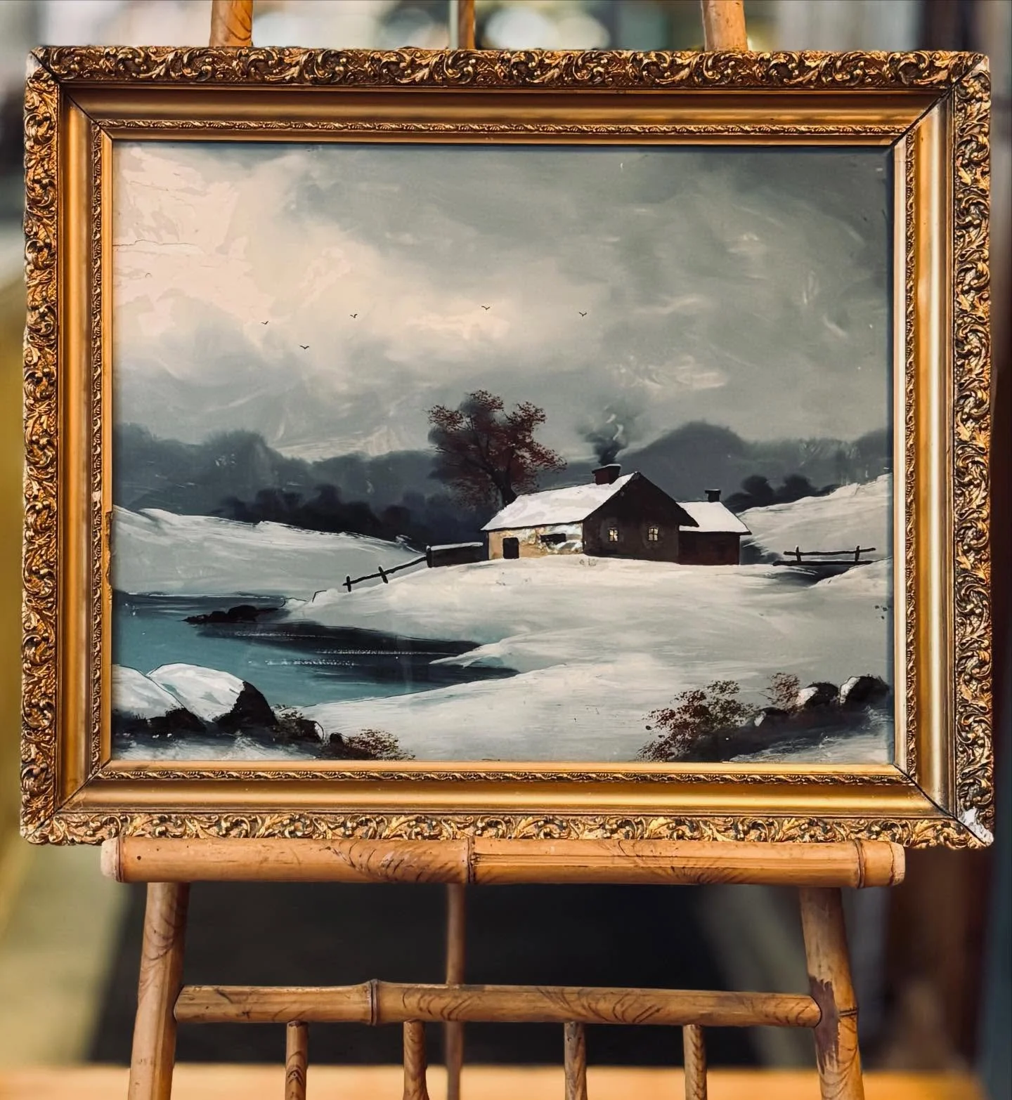 This is what winter dreams look like. It seems fitting that we&rsquo;re adding this to our shop as it flurries. A glowing cottage, fresh snow, quiet water, and the magical shine of antique reverse glass painting. Perfect for holiday decorating or yea