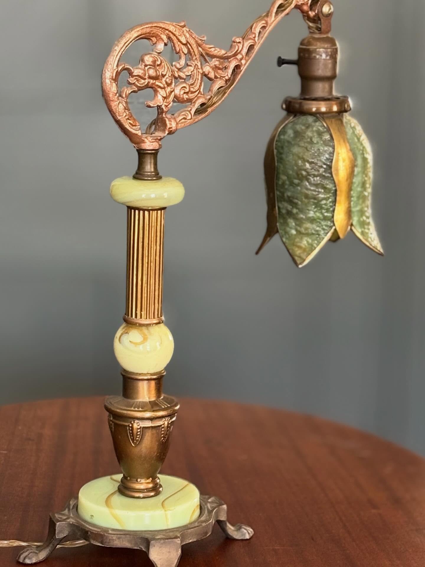 This antique adjustable table lamp dates to the early 20th century and showcases cast metal ornamentation&mdash;hallmarks of the Art Nouveau movement. The arched arm design classifies it as a &ldquo;bridge lamp,&rdquo; a popular style for desk or rea