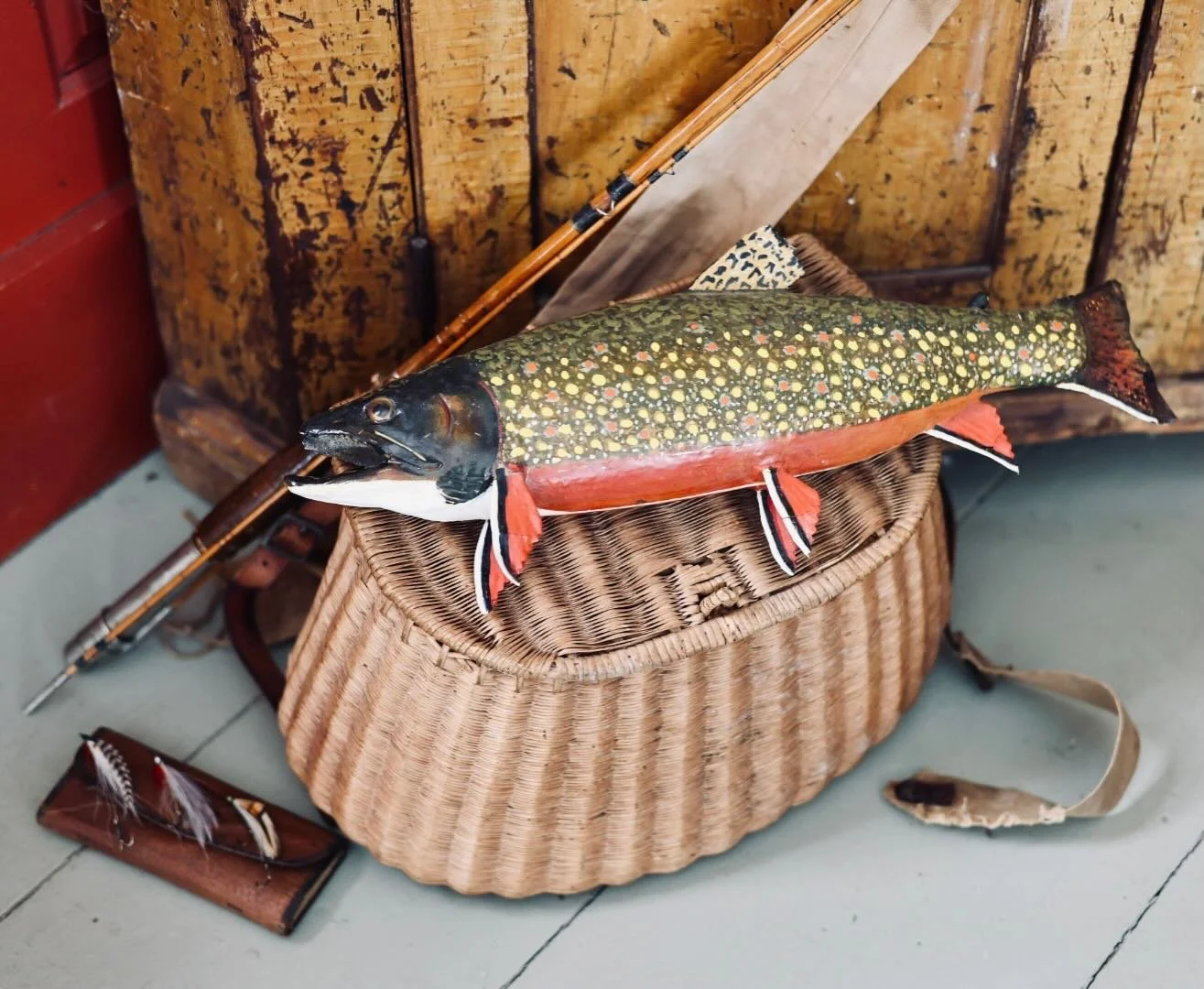 An old creel, a brook trout, and a handful of flies&mdash;pieces that feel right at home in a Maine camp, shaped by time and use.

Fly fishing has long been part of Maine&rsquo;s rhythm, with anglers traveling north more than a century ago for the co