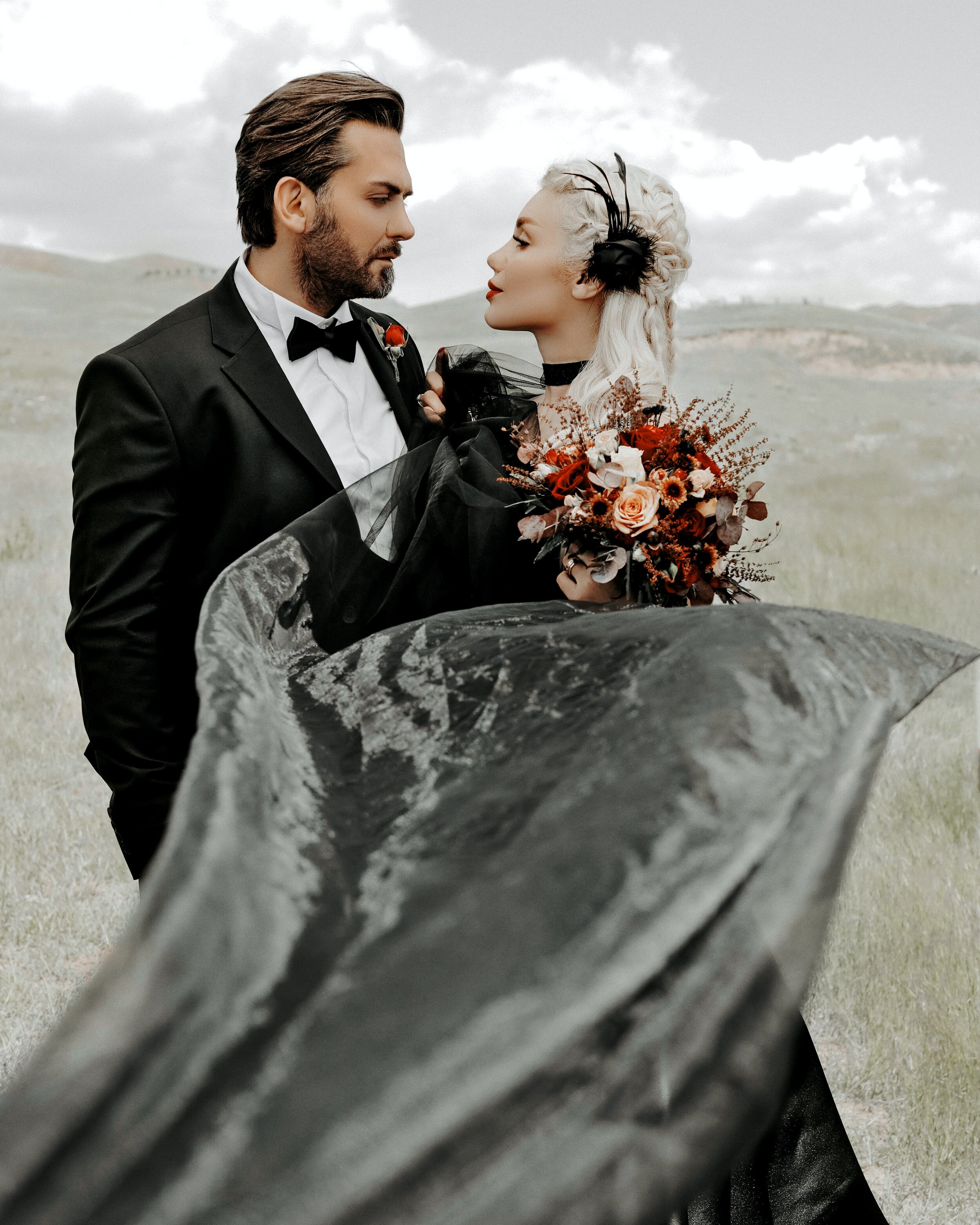 man-in-black-suit-holding-bouquet-of-flowers-3650469.jpg