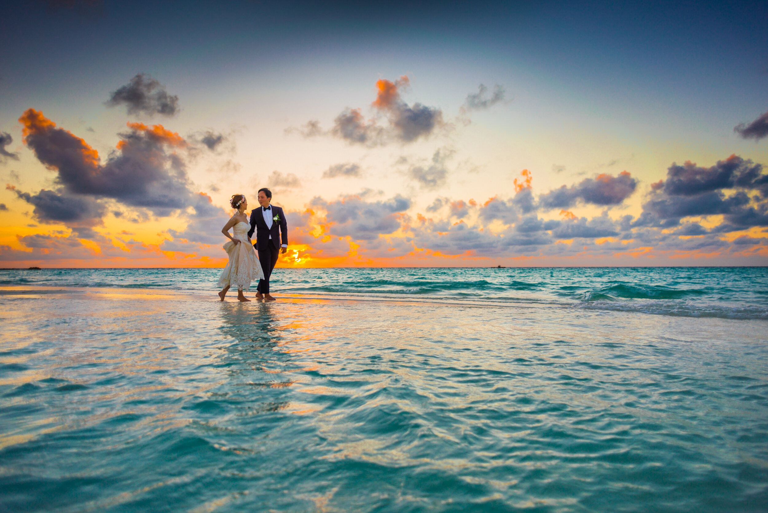 Man and Woman Walking of Body of Water.jpg