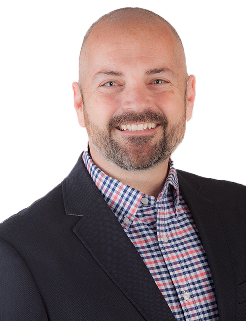This is a picture of Ronnie DeBenedetta, a home sales Realtor. In the picture, he is smiling and is dressed professionally.