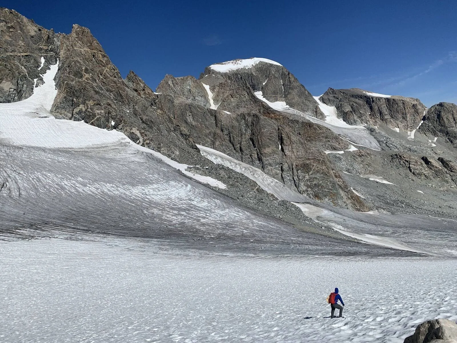 hiker-crossing-glacier-teton-mountains-wyoming.jpg