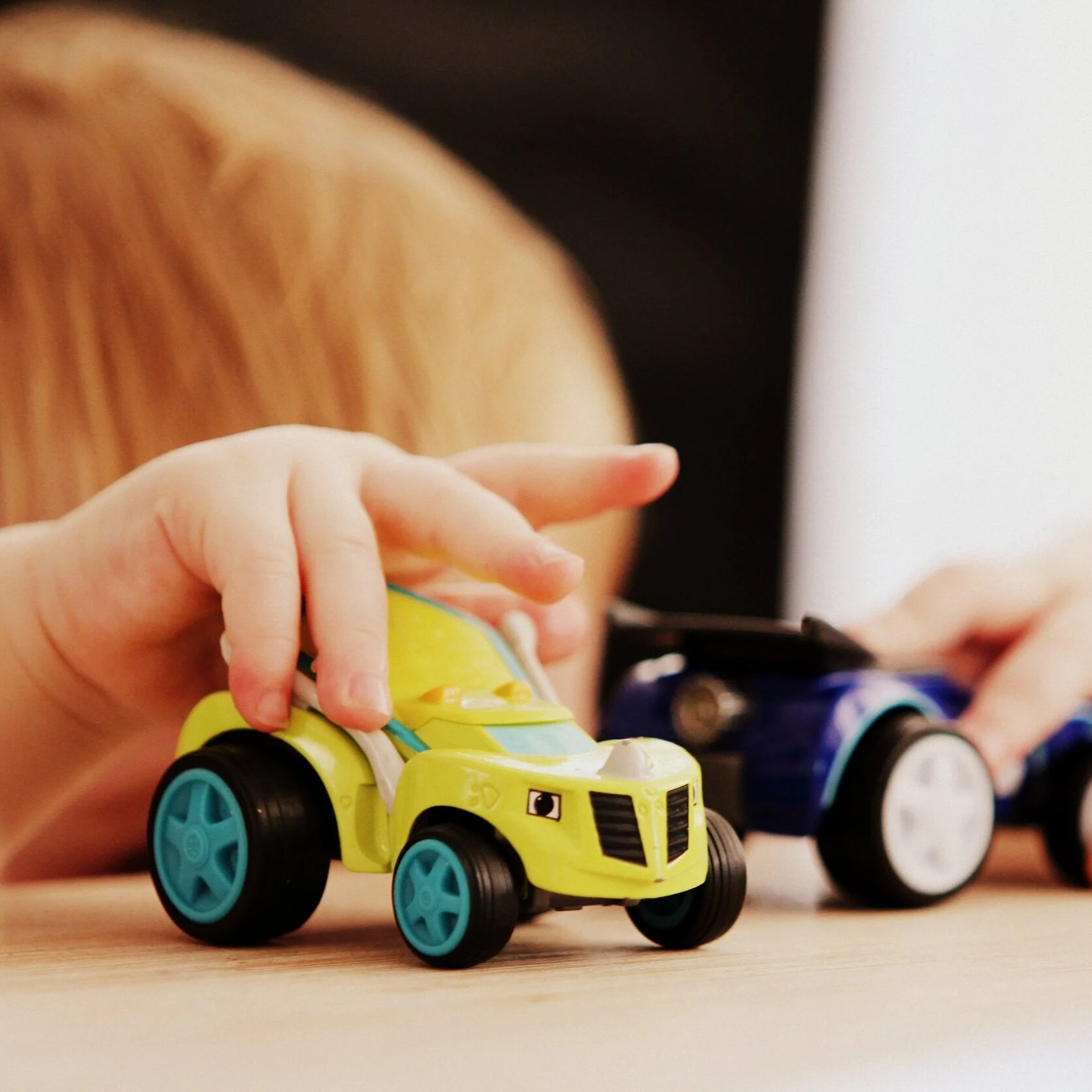Child playing with toy cars