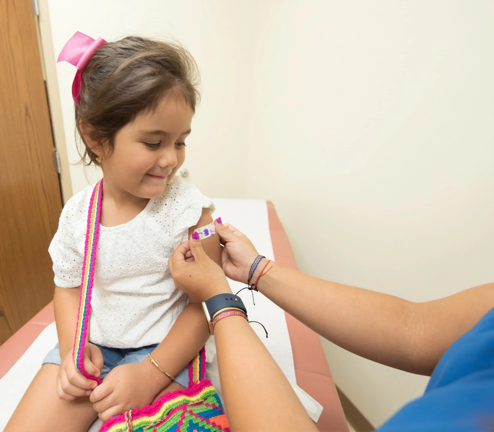 Young female patient looking at her band-aid