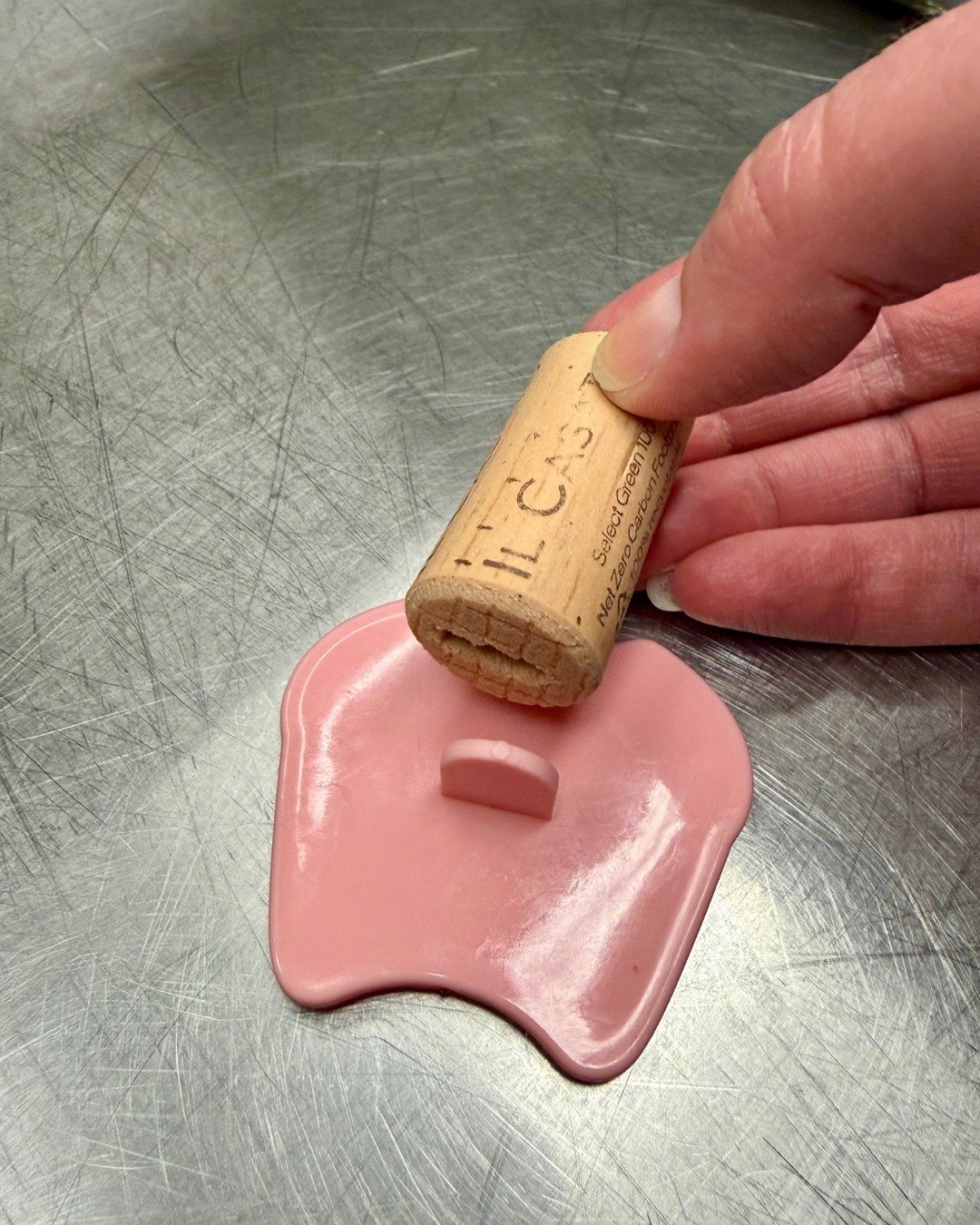 Adaptative tools alter how something works based on user needs. Who would have thought a wine cork could be an adaptive tool in our kitchen? 

One of our volunteers had the amazing idea to help extend the handles of our specialty dog treat cutout sta