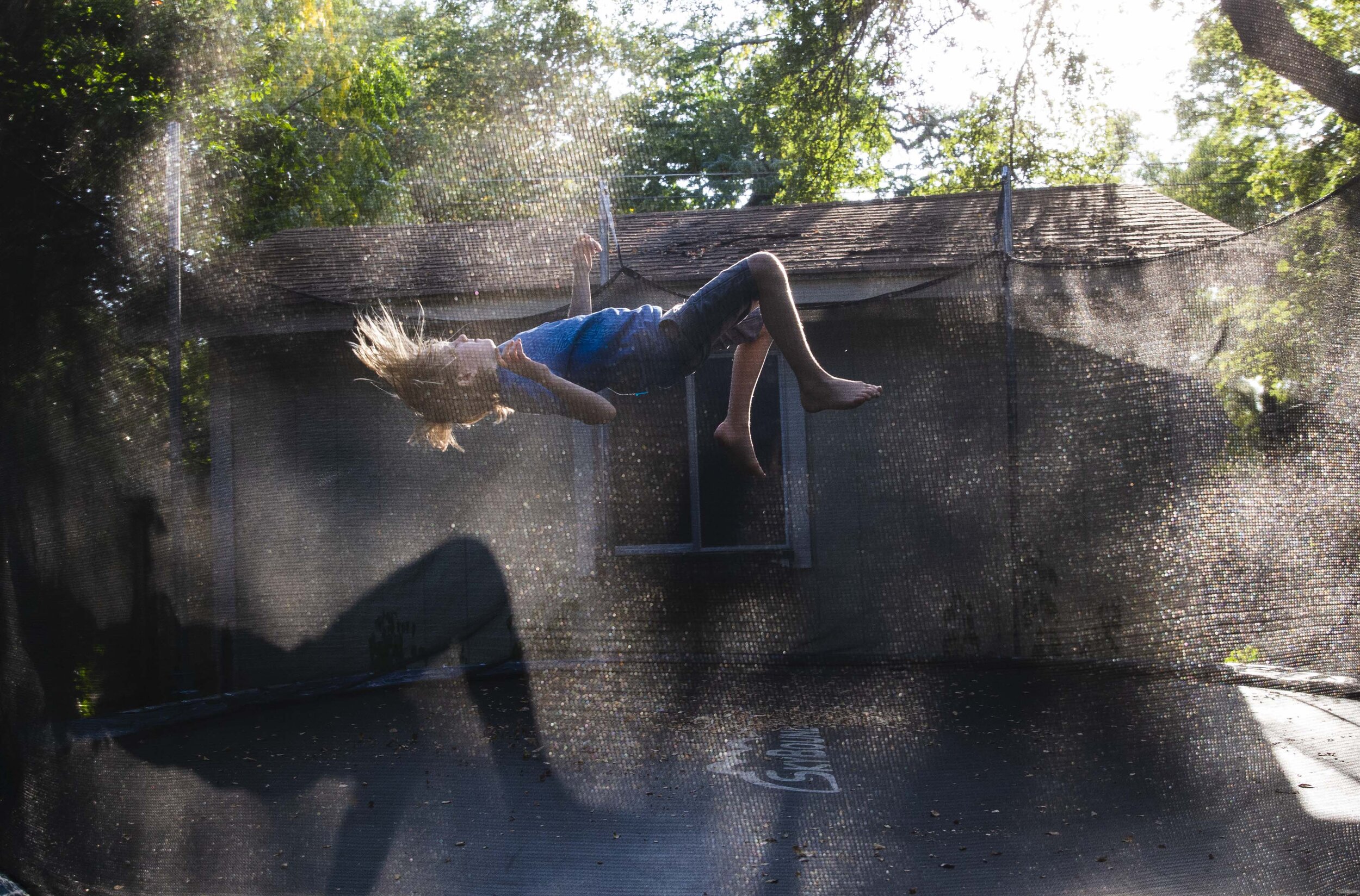 Keegan, a gender creative child, then 8, bounces on the trampoline outside his families home in Austin, Texas, U.S., August 22, 2018.  Identifying as gender creative, Keegan’s parents have made the ch